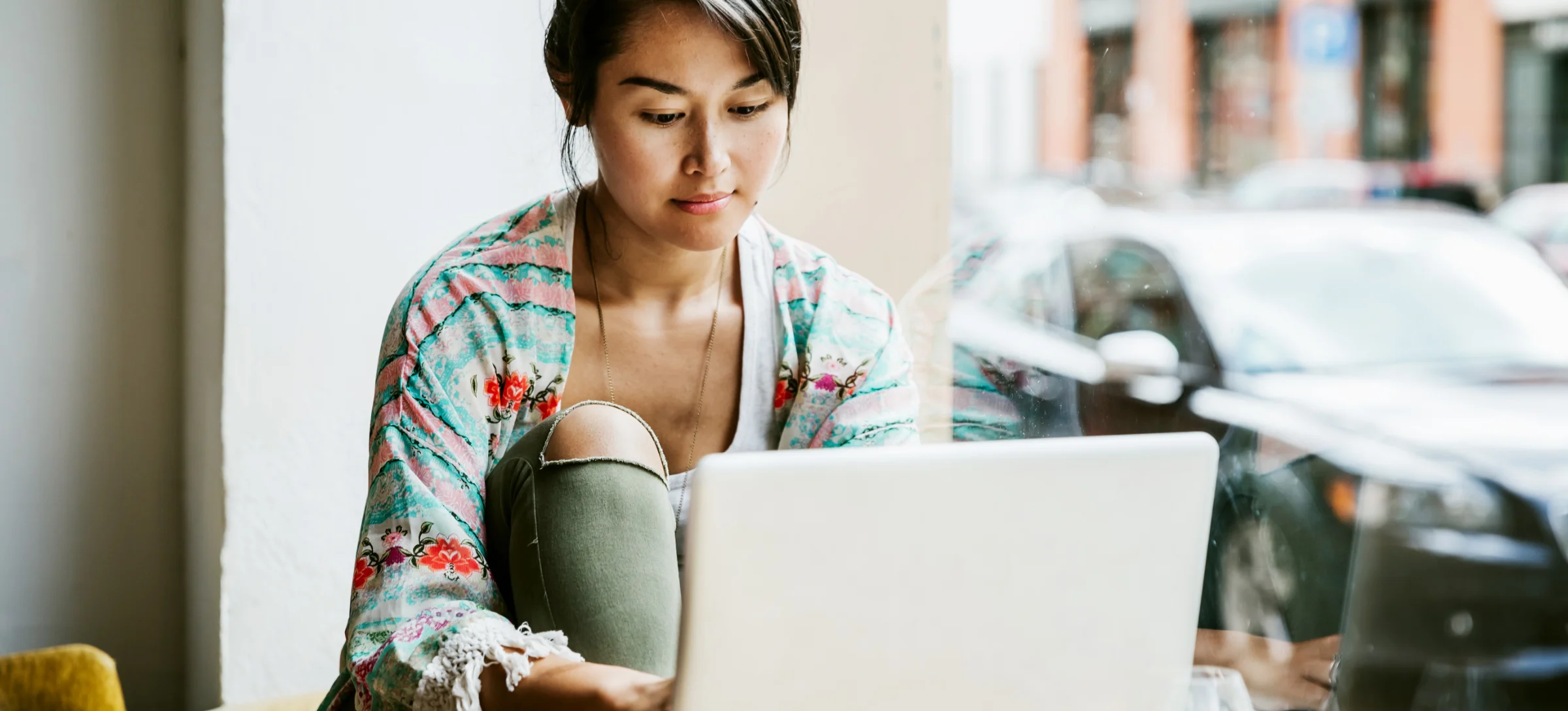 [Featured Image] A computer science learner works on their laptop while studying routing tables and their role in computer networking. 

