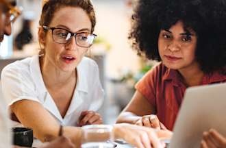 [Featured Image] A group of employees discuss the effects of the attention economy on their business.