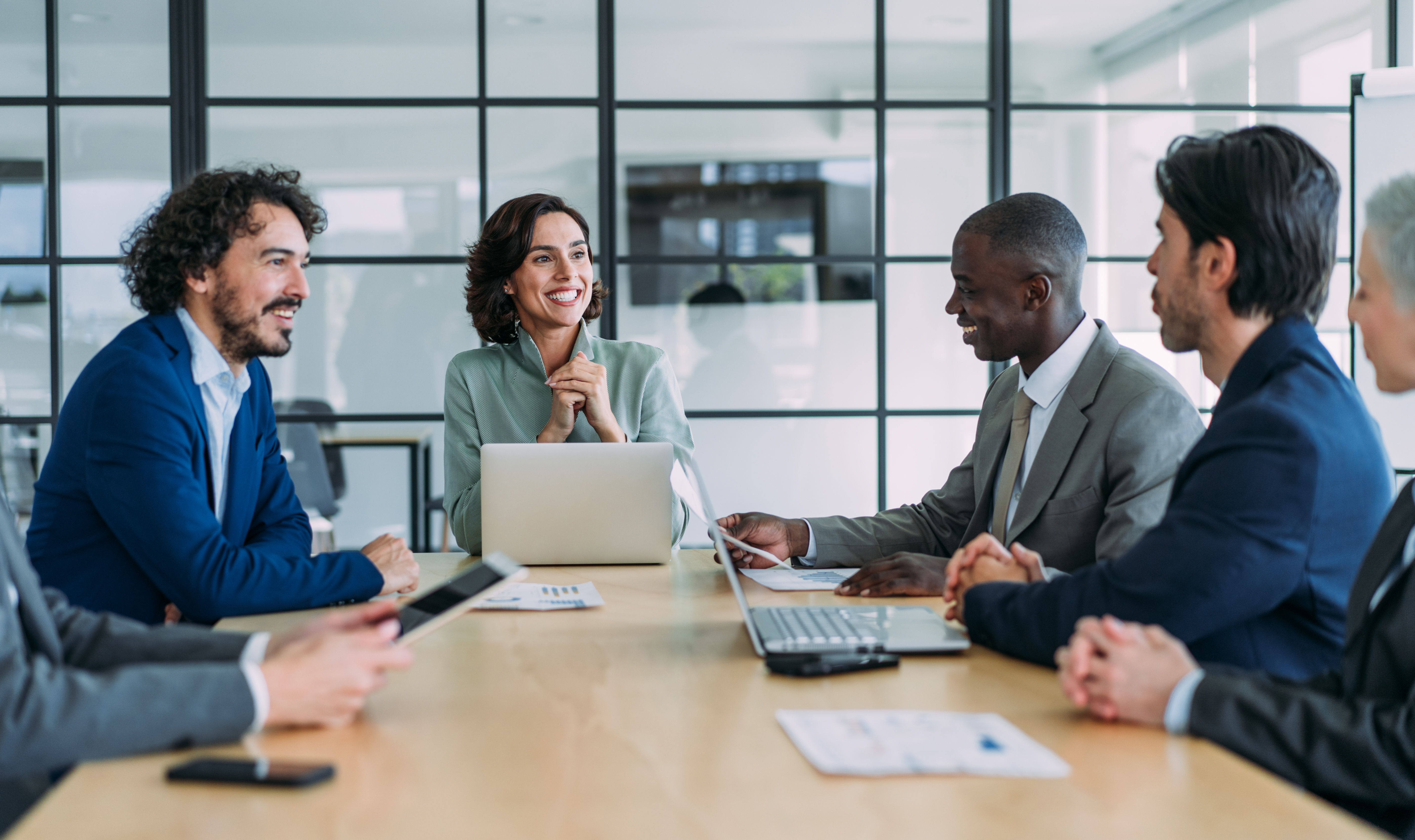 [Featured Image] Business professionals in a meeting discussing the importance of business administration certifications in a professional workspace.
