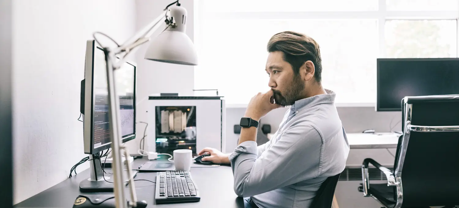 [Featured Image] A neural network engineer analyzing data on a computer screen in a brightly lit office settting.
