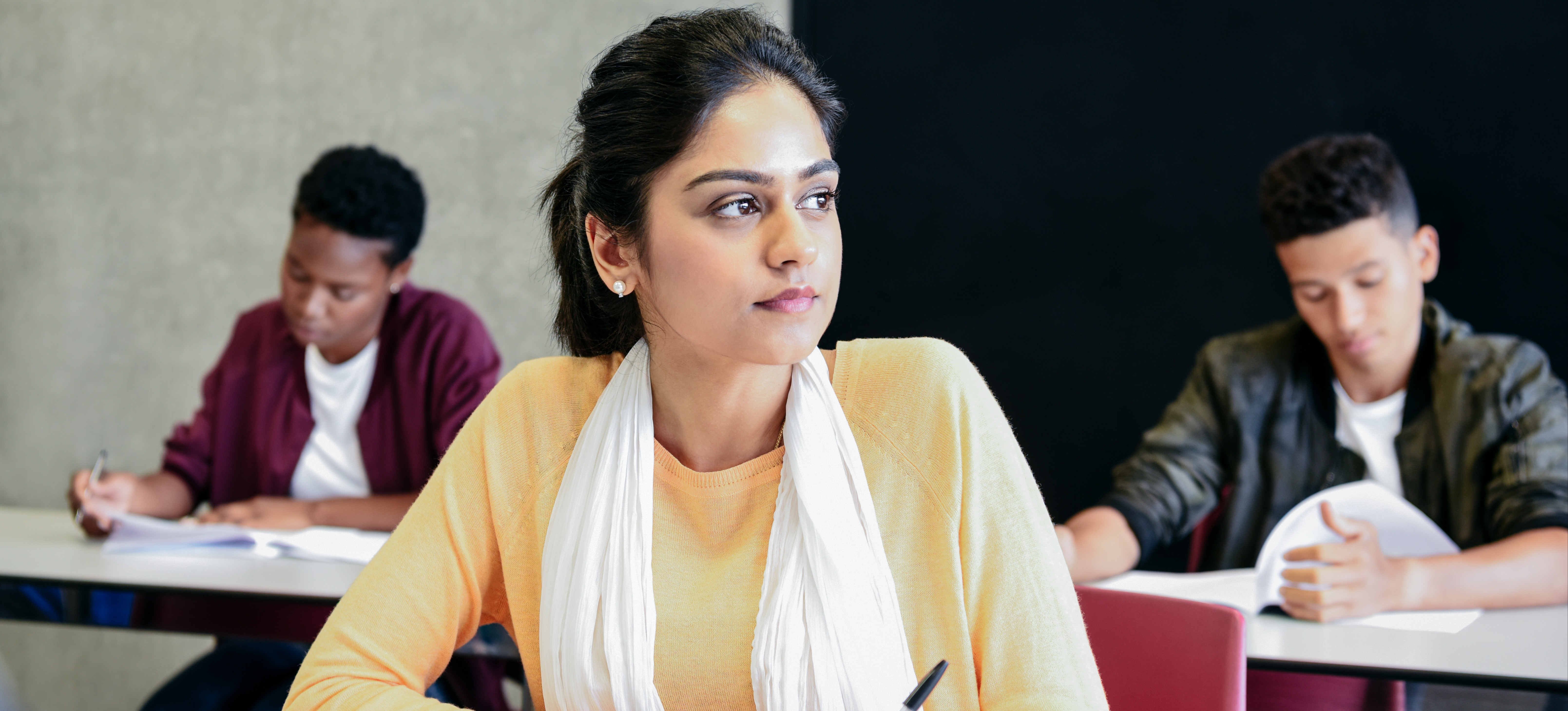 [Featured Image] A student sits in a classroom and thinks about how to prepare for UPSC.
