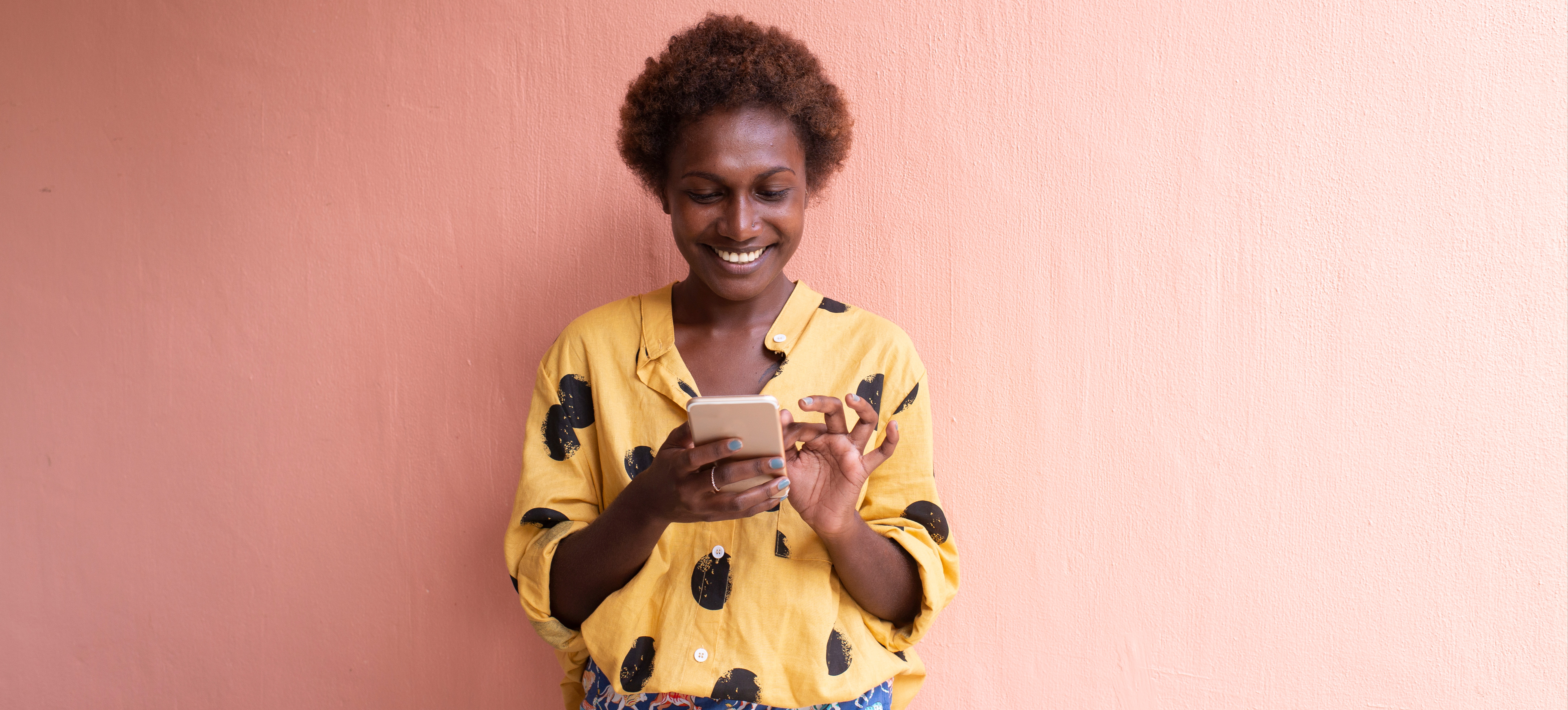 [Featured Image] A person stands outside using a smart phone.