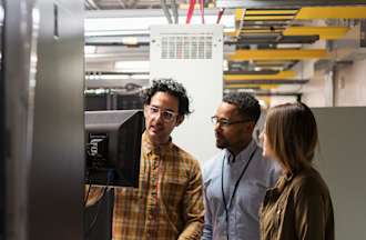 [Featured Image]: QA tester, working with the team reviewing quality standards while developing the latest product. 