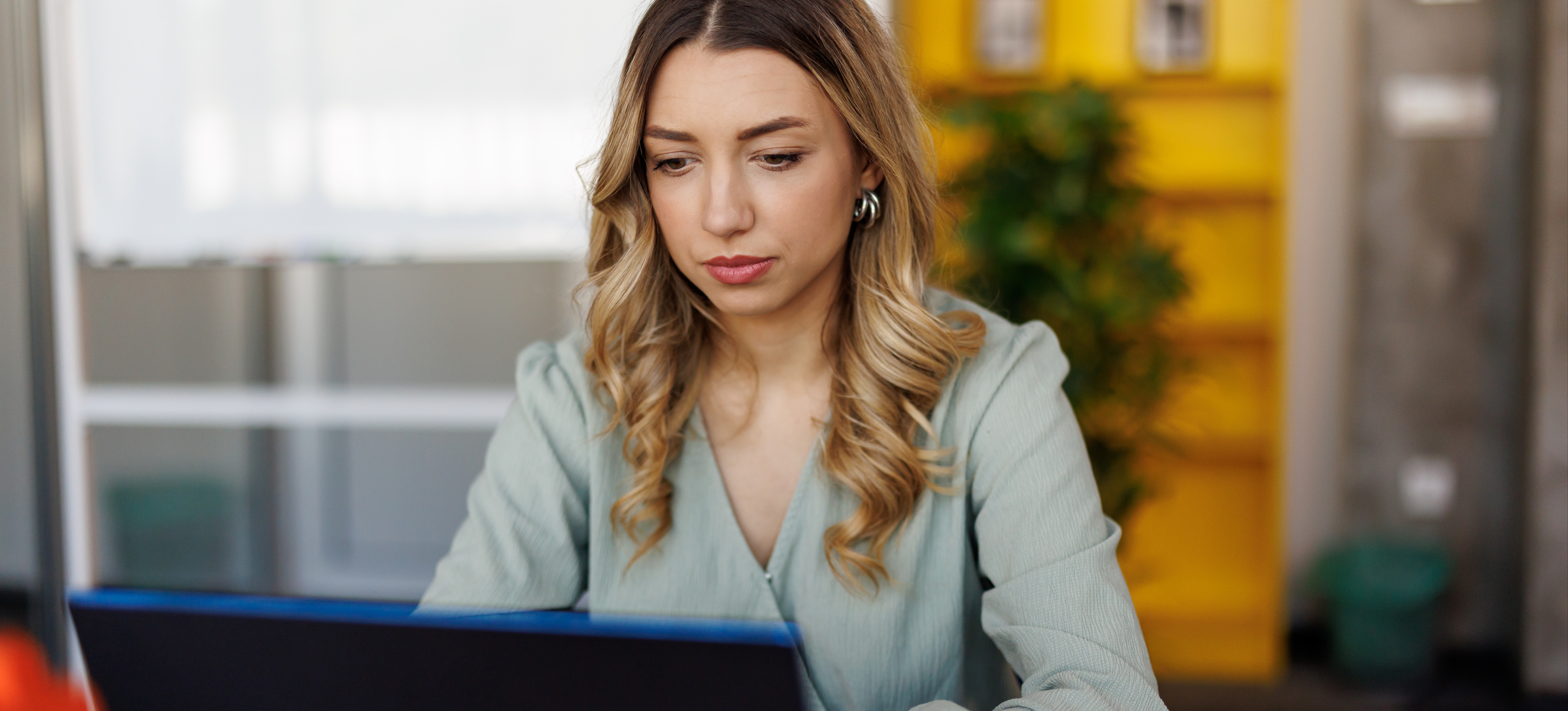 [Featured image] A project manager sitting at a desk in a modern office plots a waterfall chart on their laptop computer.