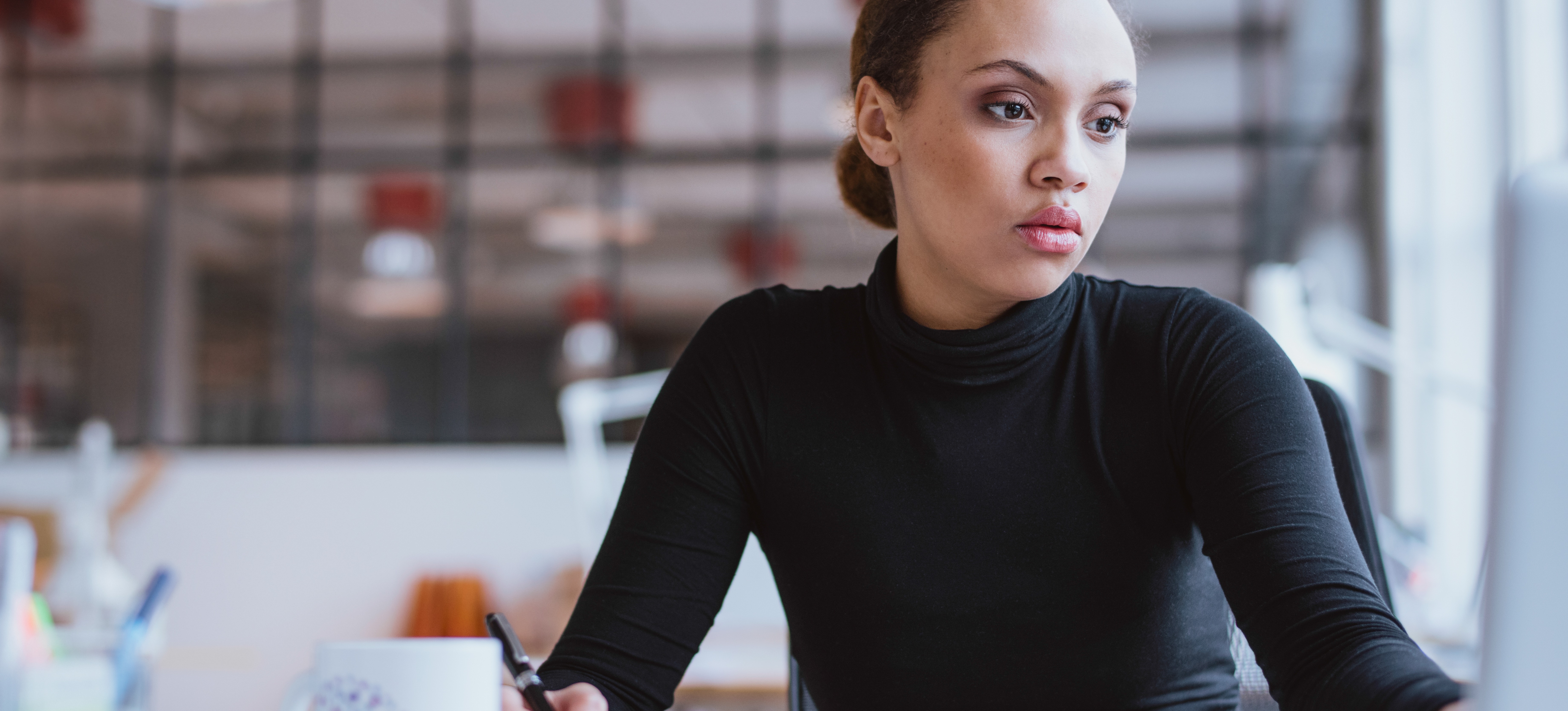 [Featured Image] An IoT specialist sits at their computer in a sunny office and develops software.
