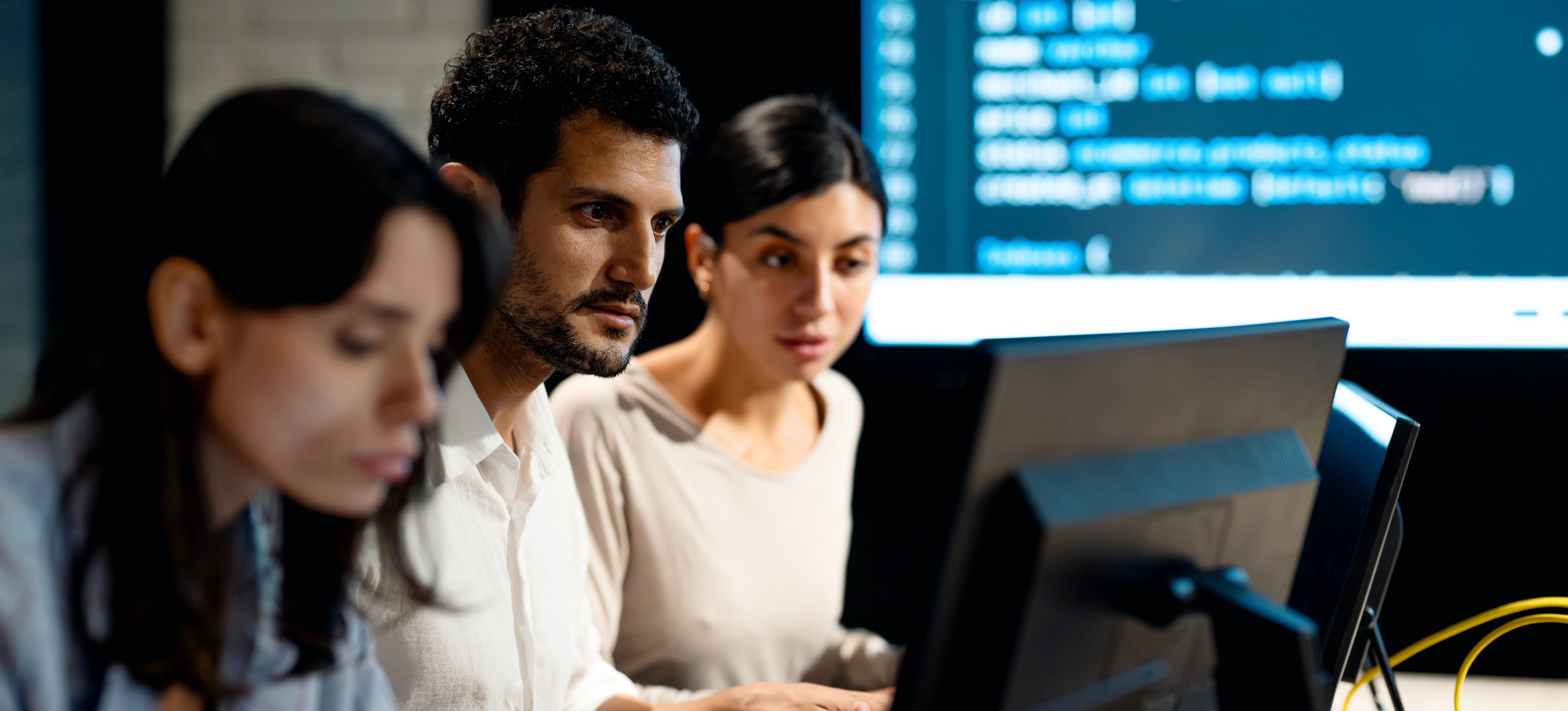 [Featured Image] A cybersecurity team in a professional work environment performing their tasks while discussing incident response and disaster recovery.
