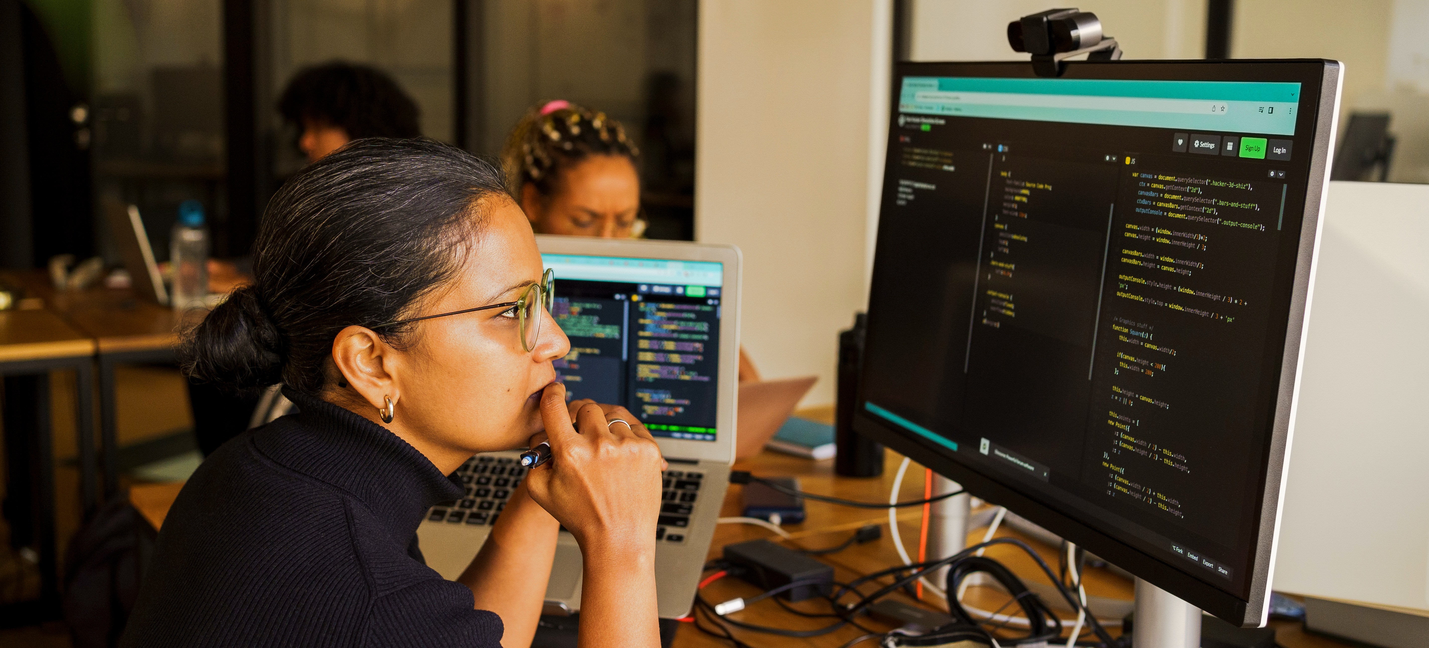 [Featured Image] After researching how to learn blockchain, an aspiring professional practices on a desktop computer located in a work environment, focused on the code displayed on the screen.
