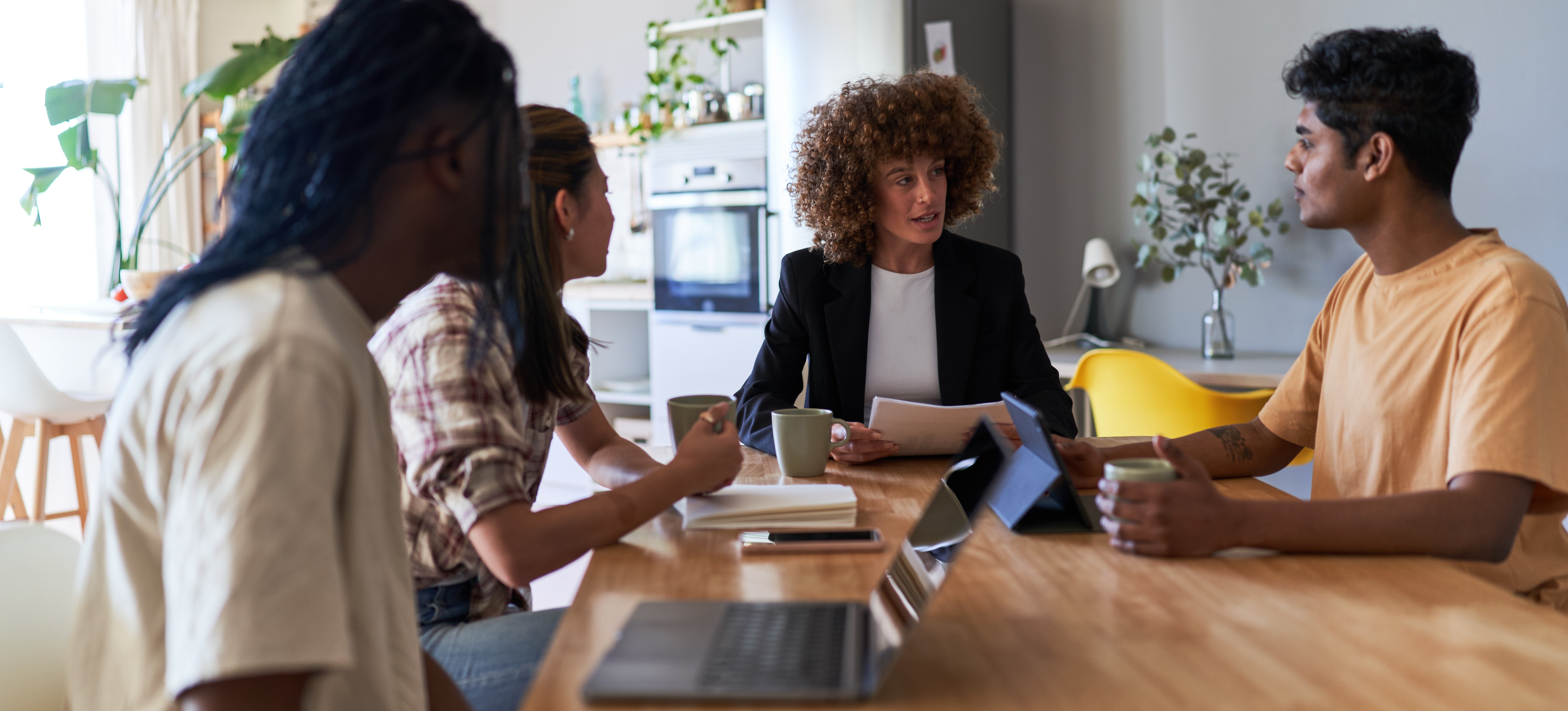 [Featured Image] A group of business systems analysts discuss their respective findings and strategies to make improvements and meet business objectives.
