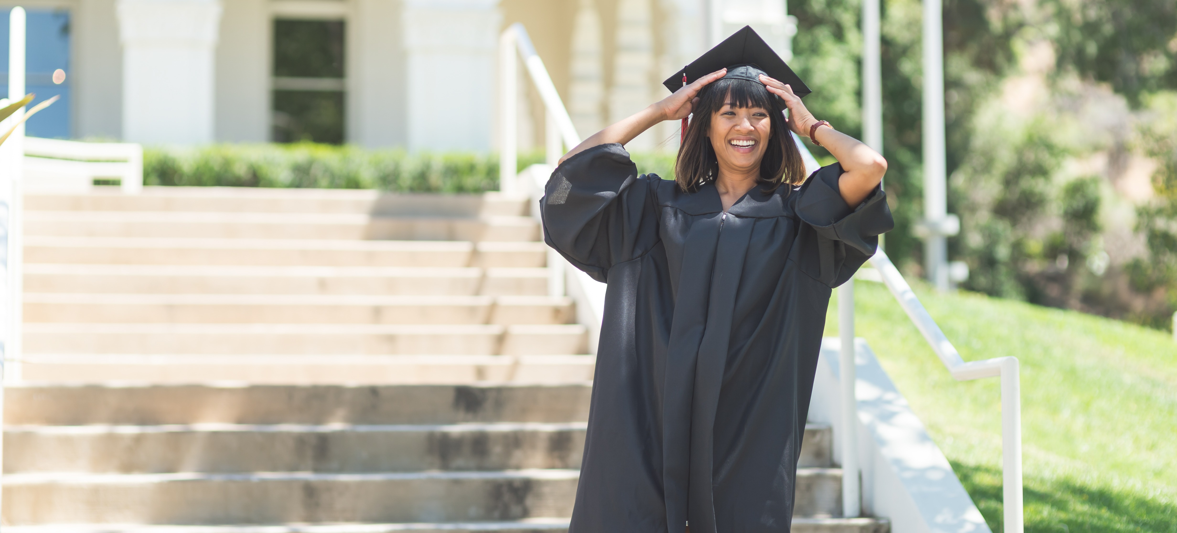 [Feature Image] A learner graduates with an early childhood education degree and prepares for their career path moving forward.
