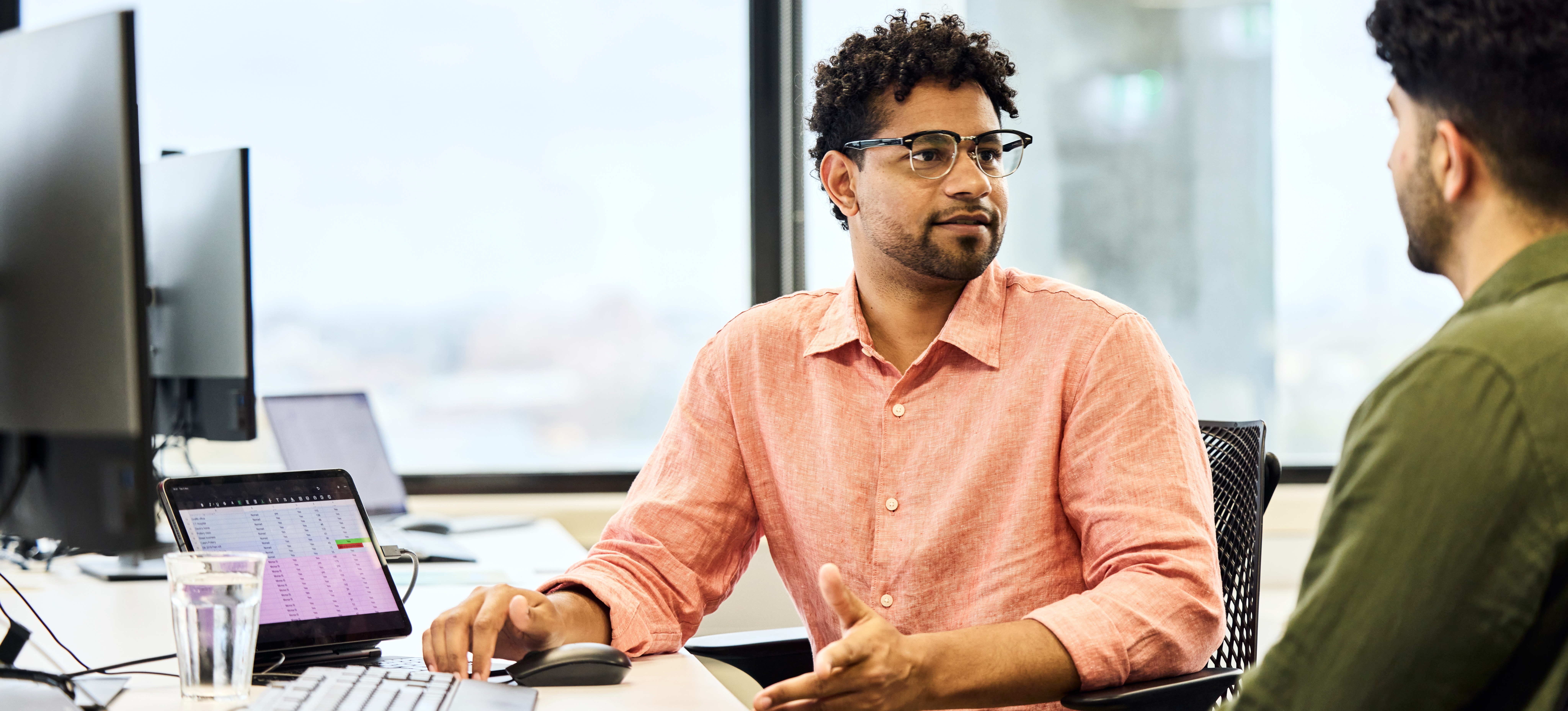 [Featured image] Two businesspeople at a computer decide between OpenStack and Kubernetes to streamline their IT infrastructure.