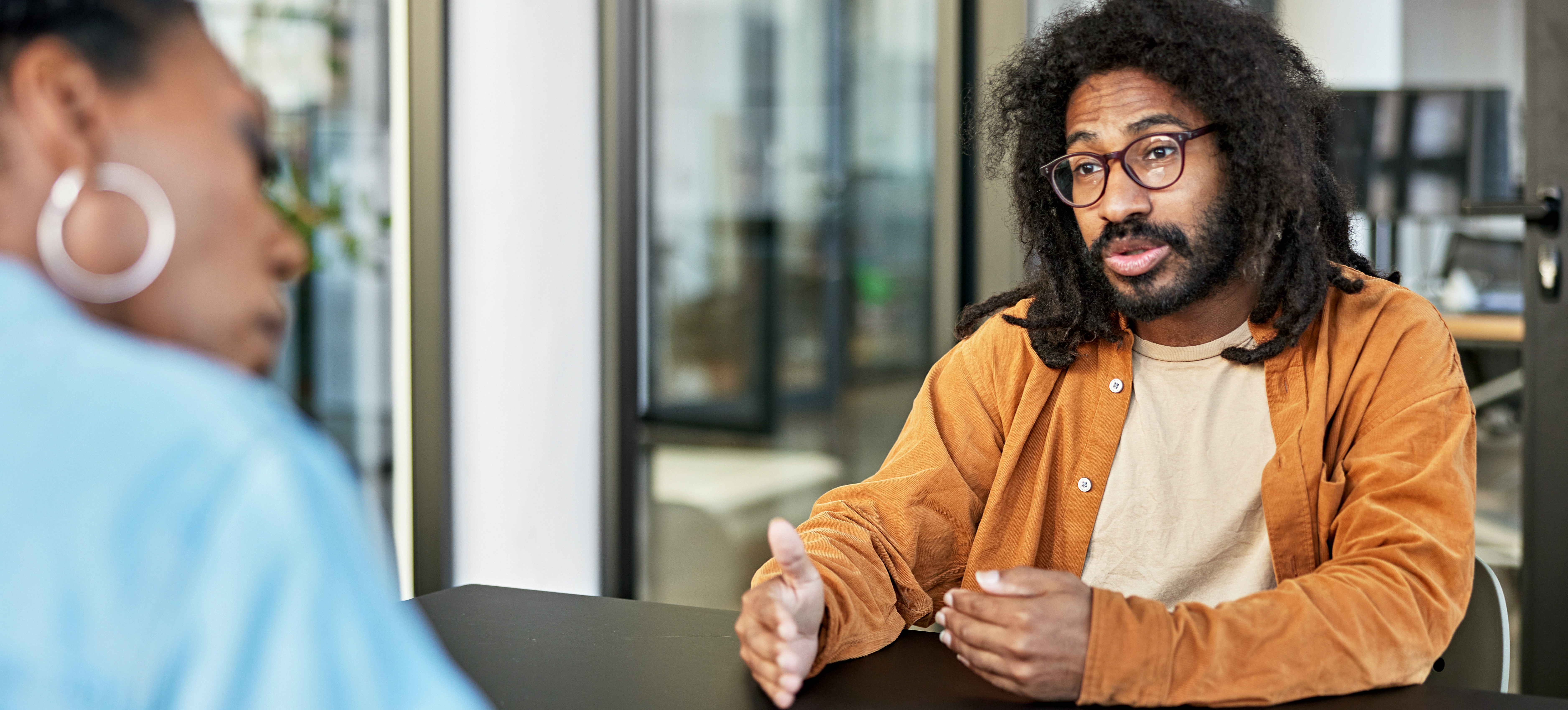 [Featured Image] A man is in an interview, answering questions about java. 