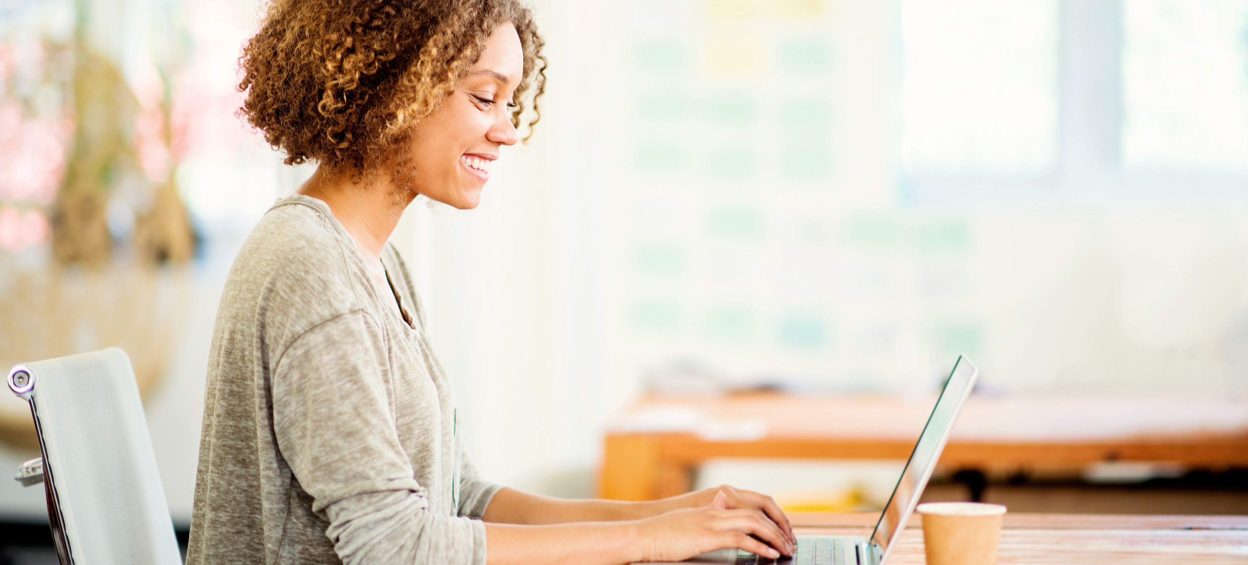 [Feature Image] A job searcher researches how to work at Amazon on a laptop as they plan their next career move.
