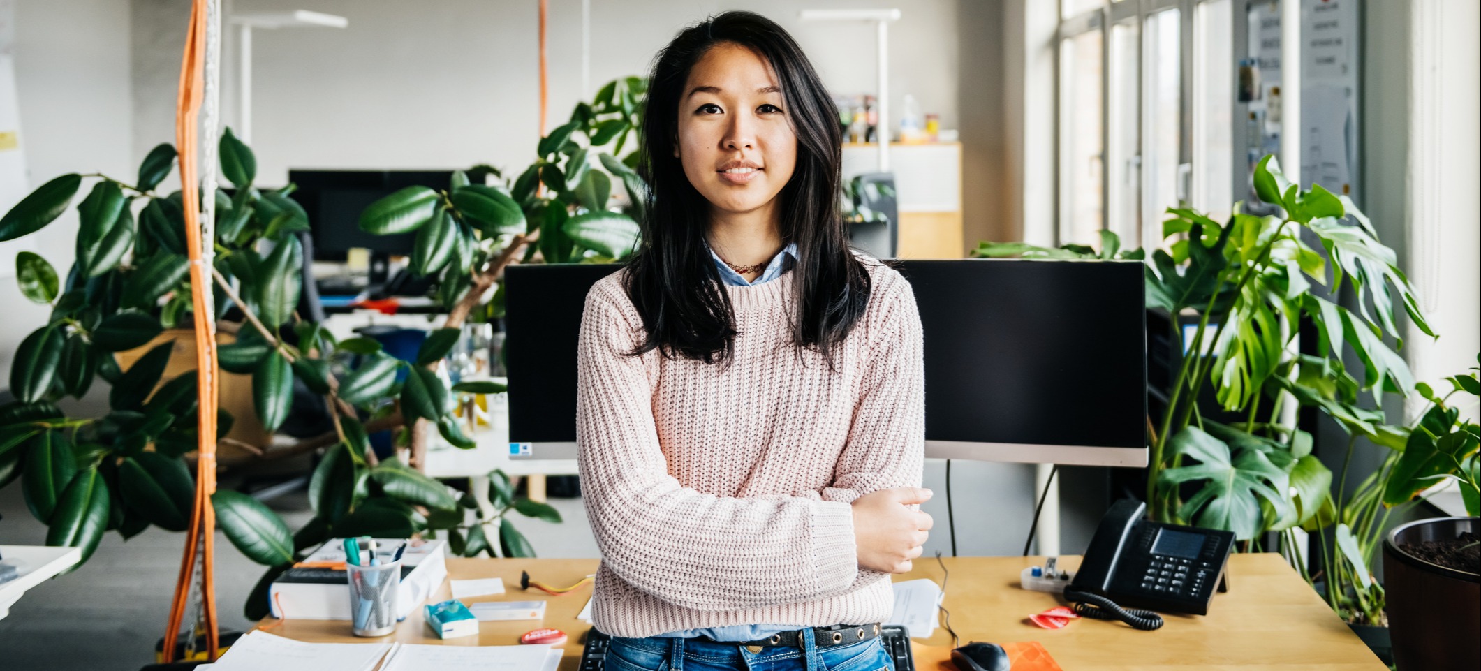 [Featured image] A DevOps engineer is sitting on their desk in the office.