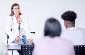 [Featured image] A nurse educator, one of the highest-paying public health jobs, speaks to students in a classroom.
