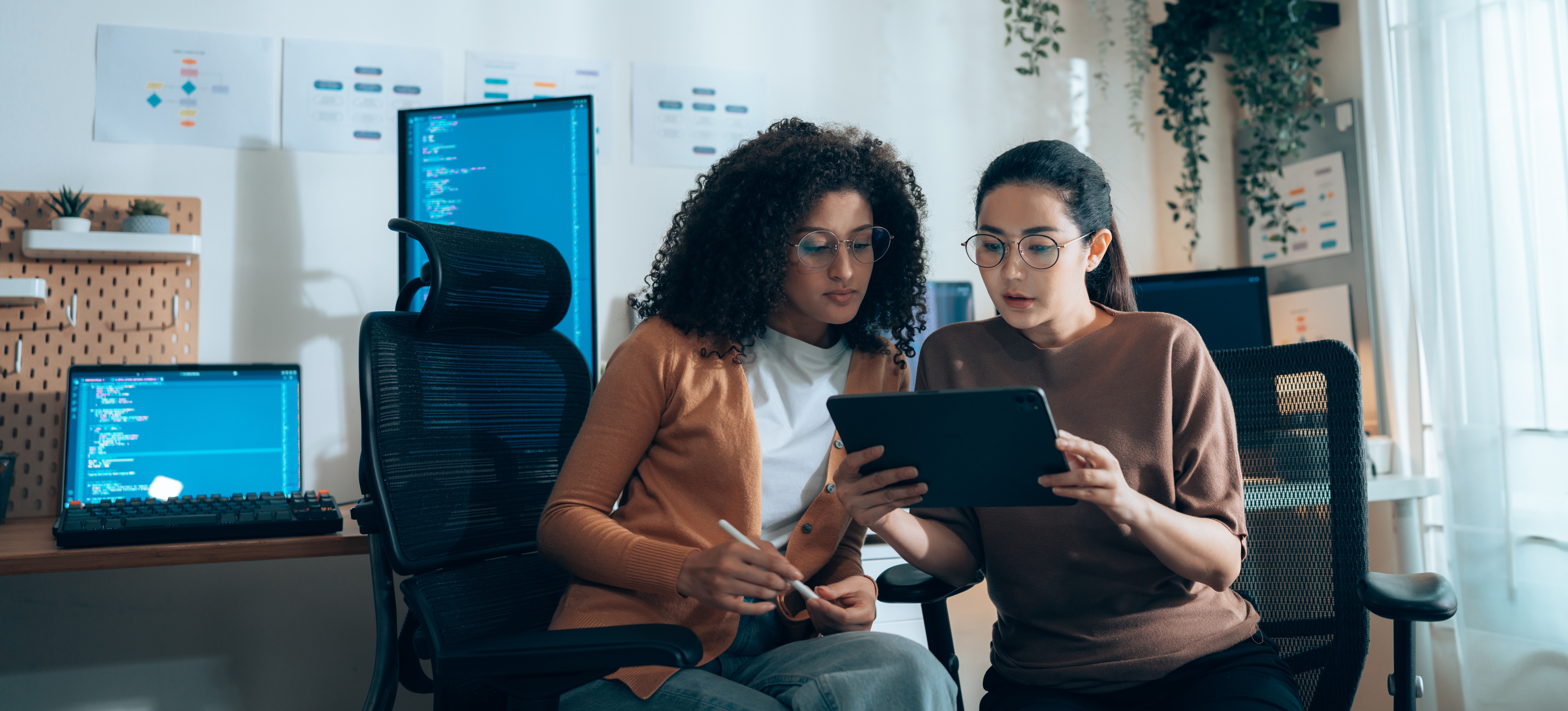 [Featured Image]: Two women use answer engine optimization to increase the company's visibility and credibility.
