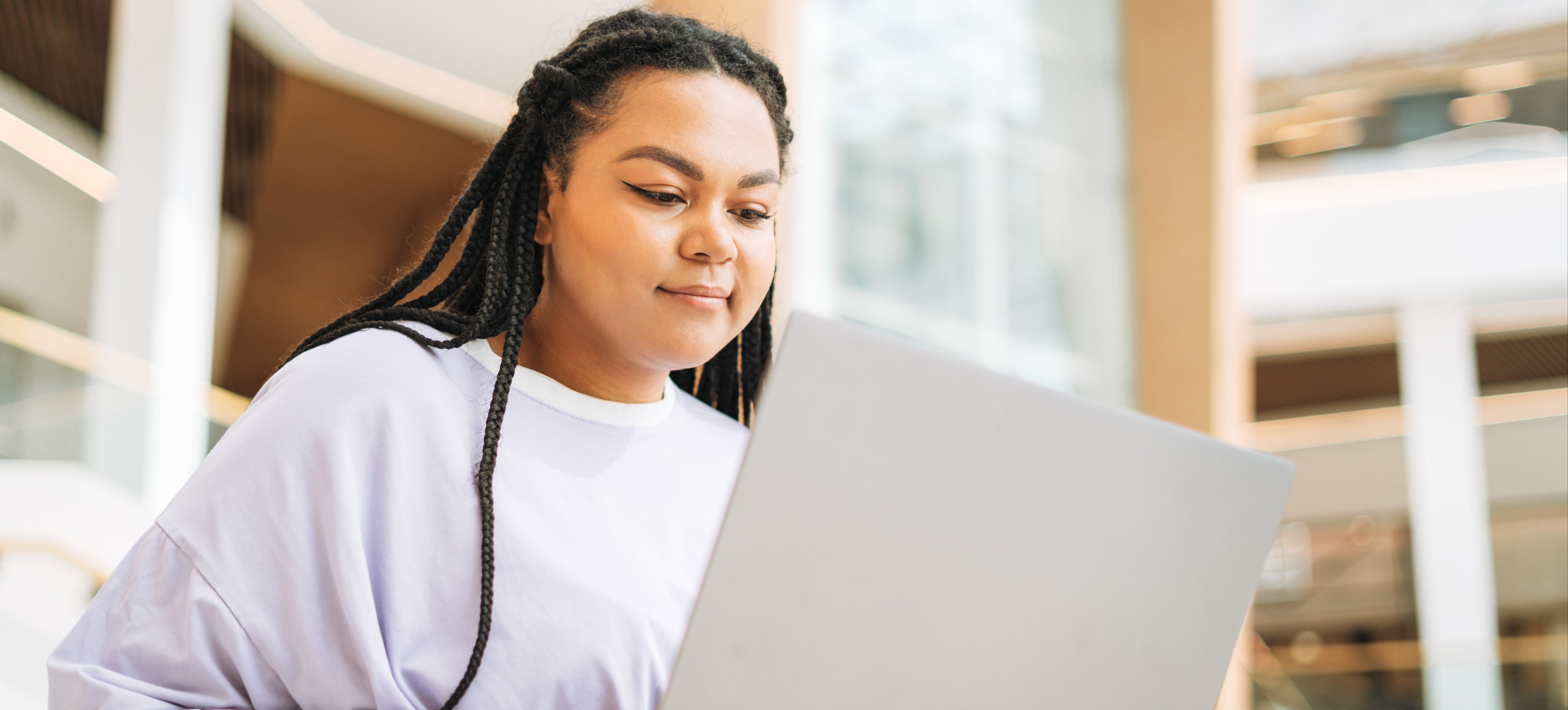 [Feature Image] A prospective learner researches online, asking college graduates, “Is a bachelor’s degree worth it?”
