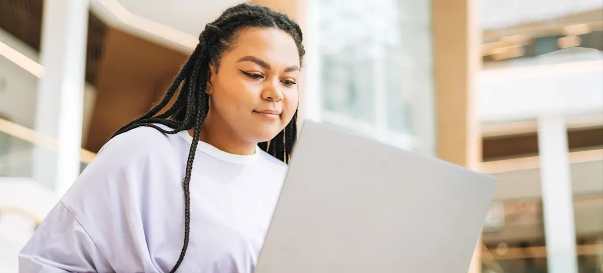 [Feature Image] A prospective learner researches online, asking college graduates, “Is a bachelor’s degree worth it?”
