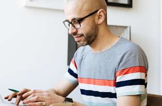 [Featured Image] A data scientist uses a MapReduce program to filter through data on his laptop. 