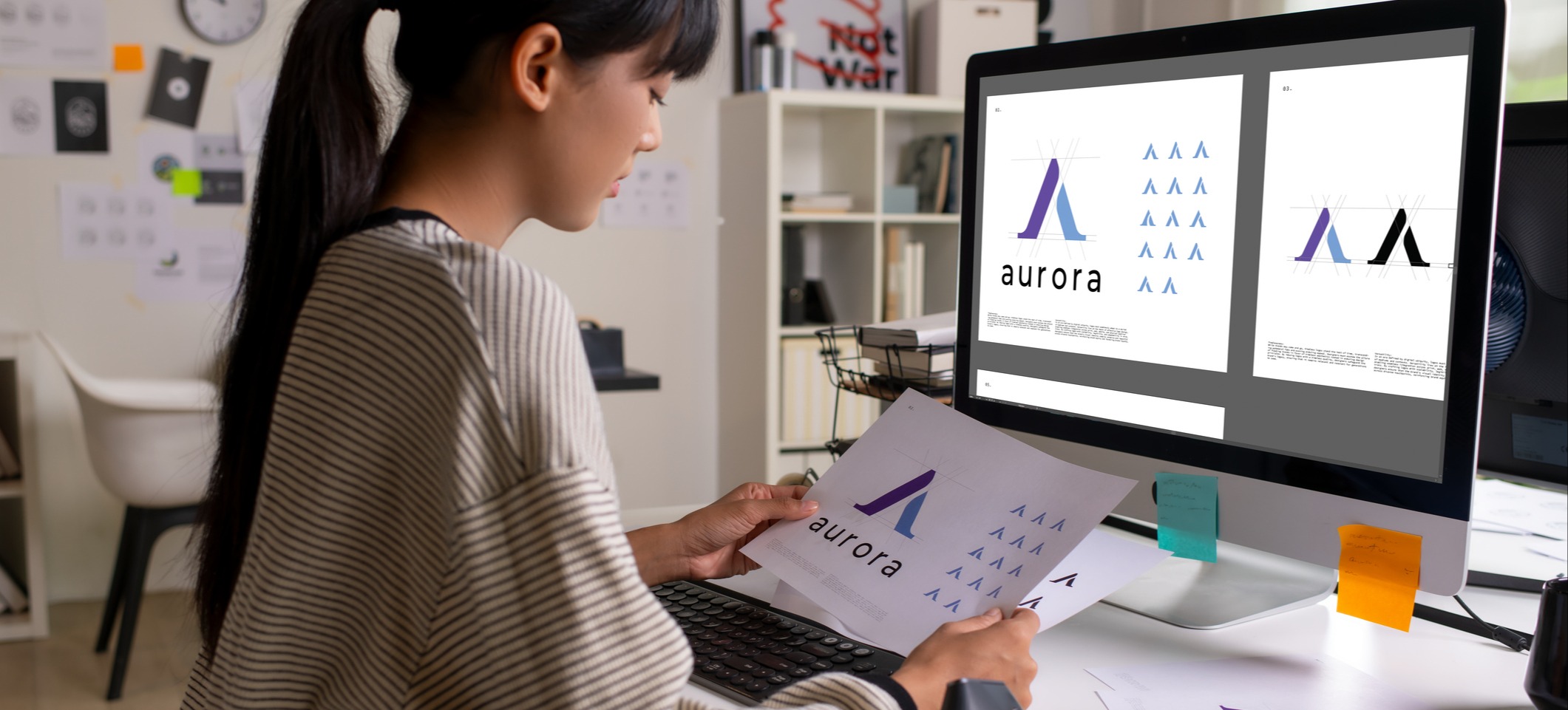 [Featured image] A graphic designer works in her home office on a logo, one of the many different types of graphic design.