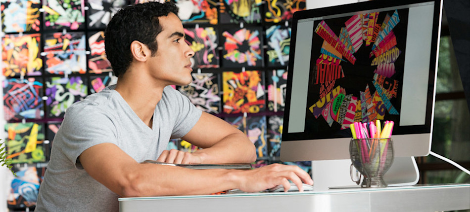 [Featured image] A graphic artist creates colorful digital artwork on their computer after learning how to sell NFTs.