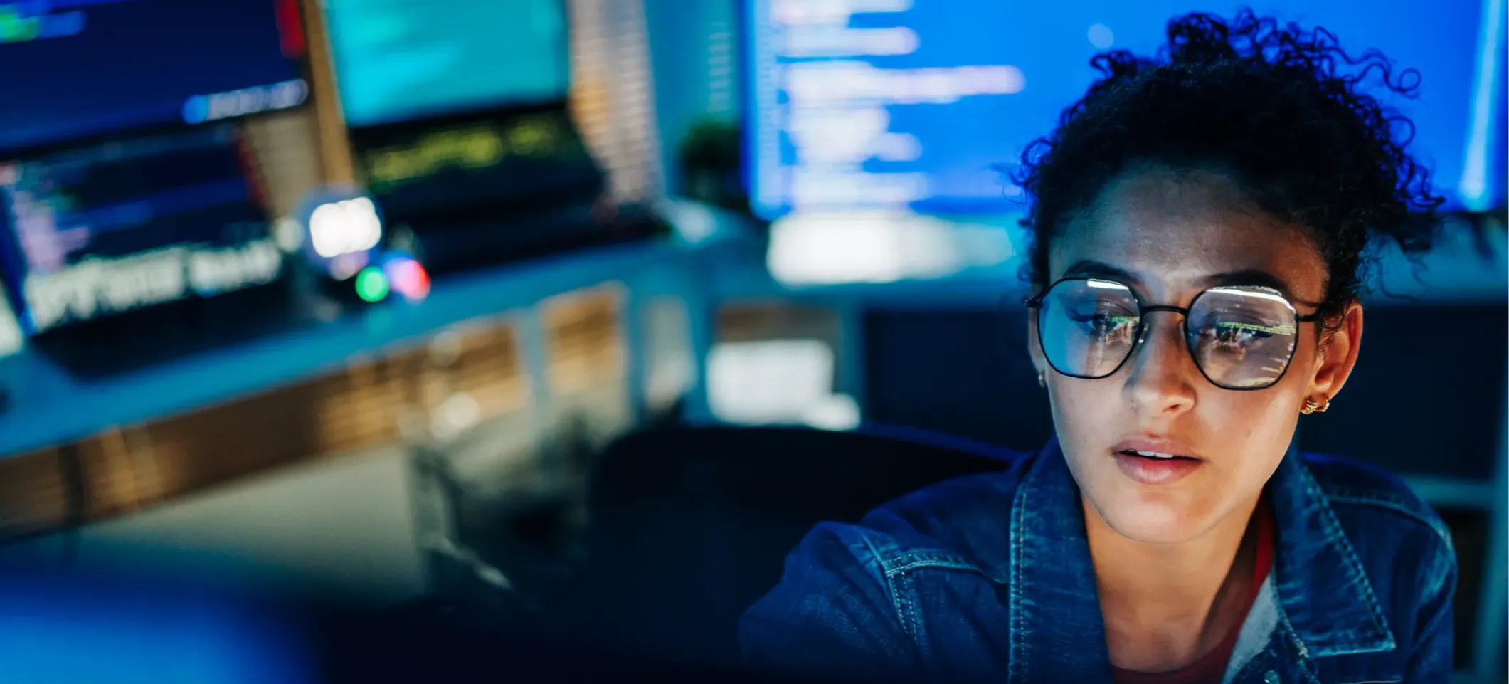[Featured Image] A cybersecurity engineer builds a firewall to regulate incoming and outgoing internet traffic. 
