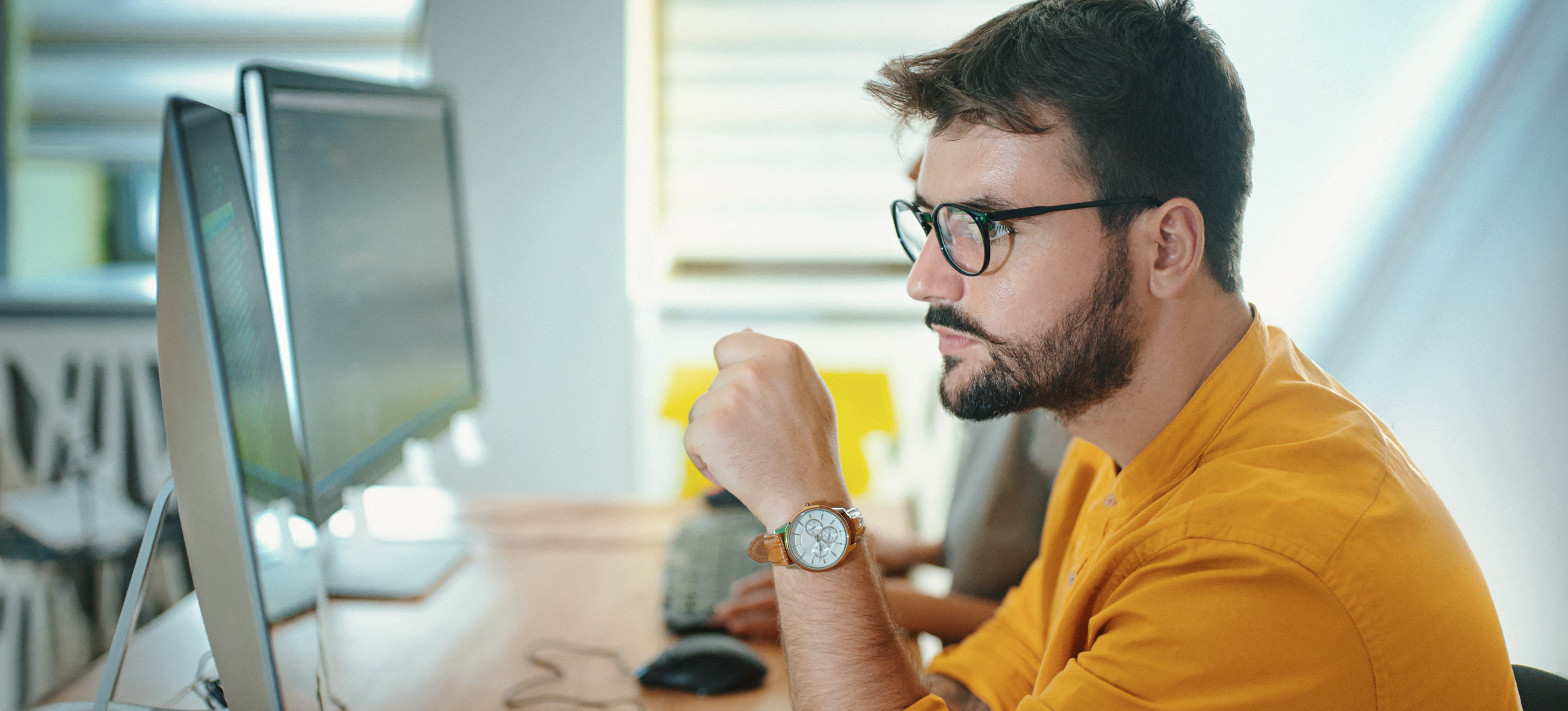 [Featured image] A machine learning engineer using neural network classification to categorize data in an office.