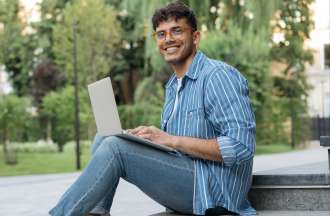 [Featured image] A college student sitting on a step outdoors applies to a data science internship on his laptop computer.