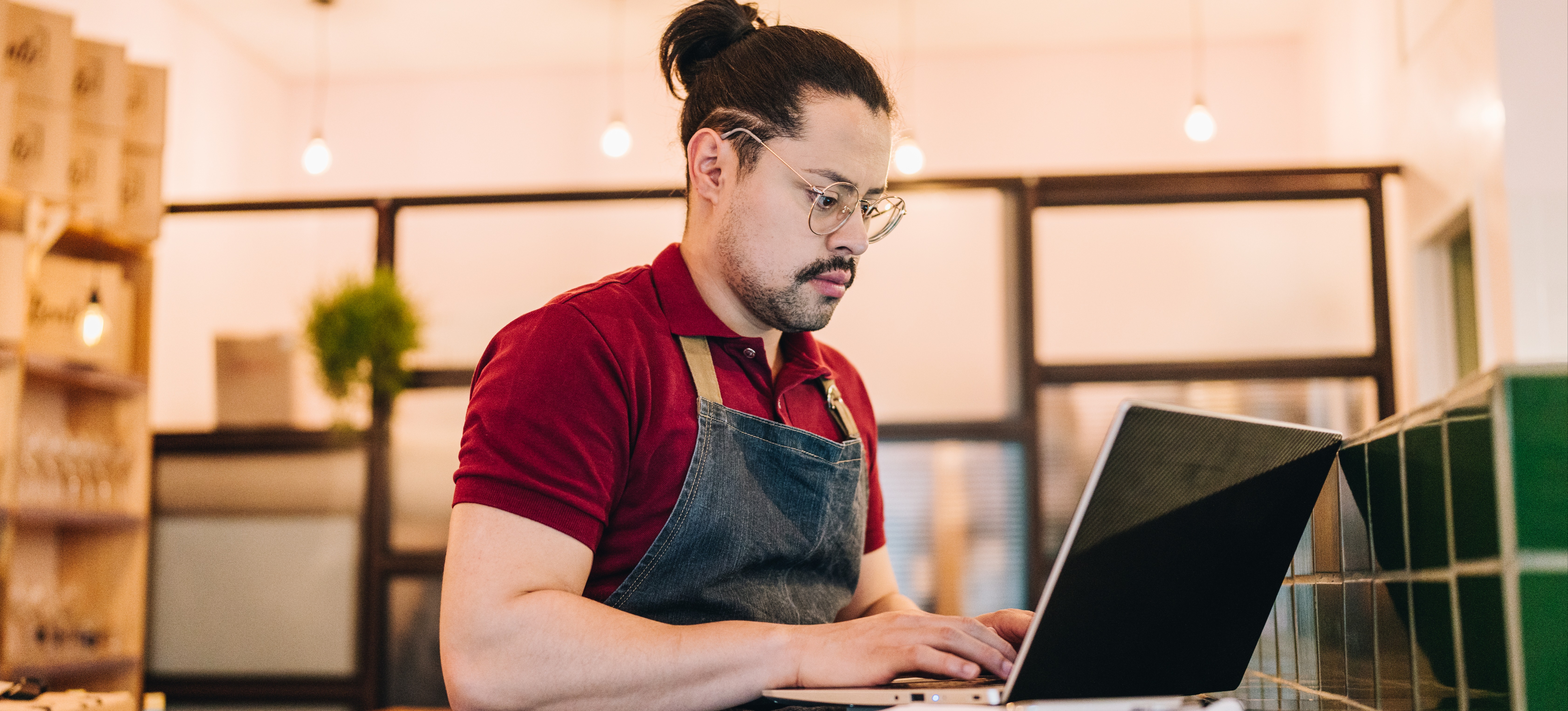 [Featured Image] A store owner and Shopify user is calculating shipping on the website for a recent sale. 