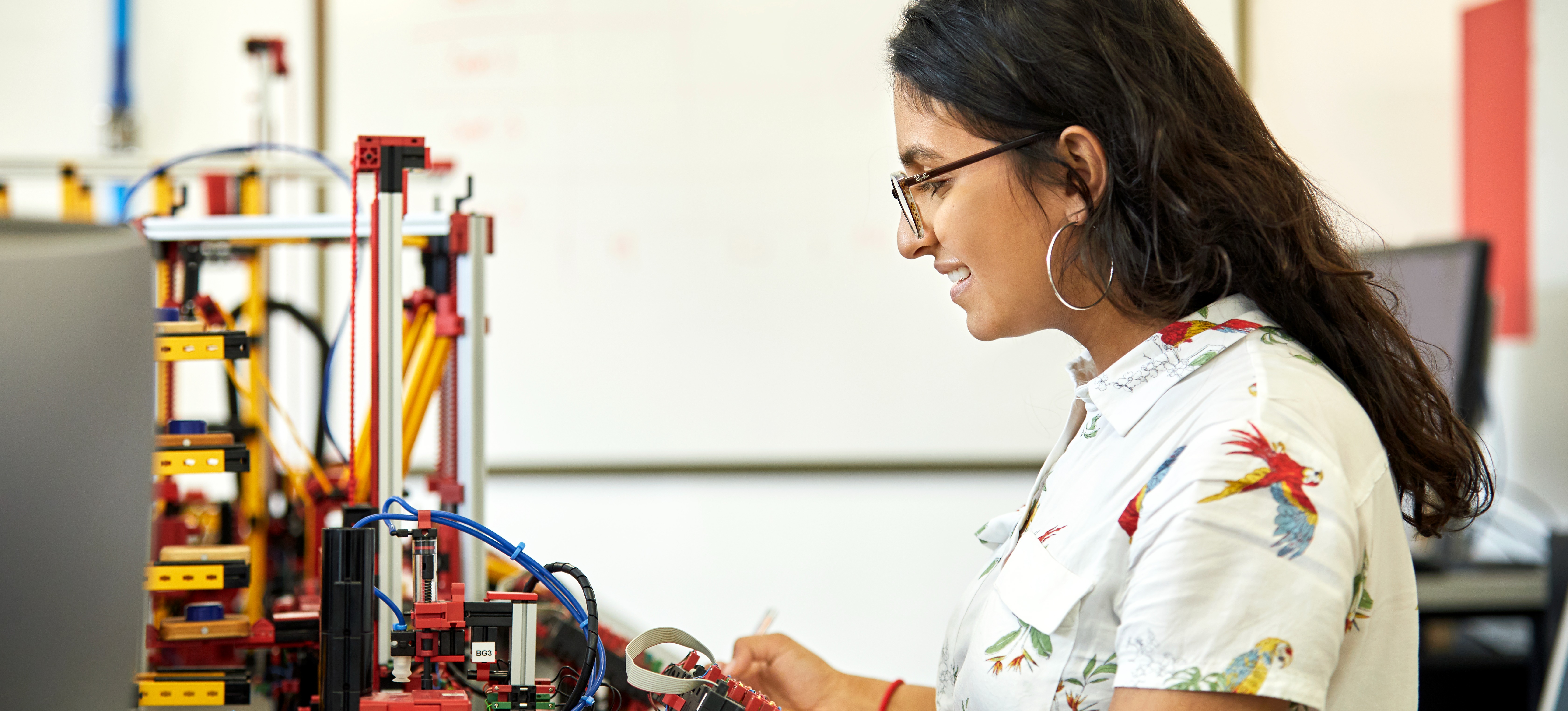 [Featured Image] An engineer considers the six degrees of freedom while examining a model at their desk.