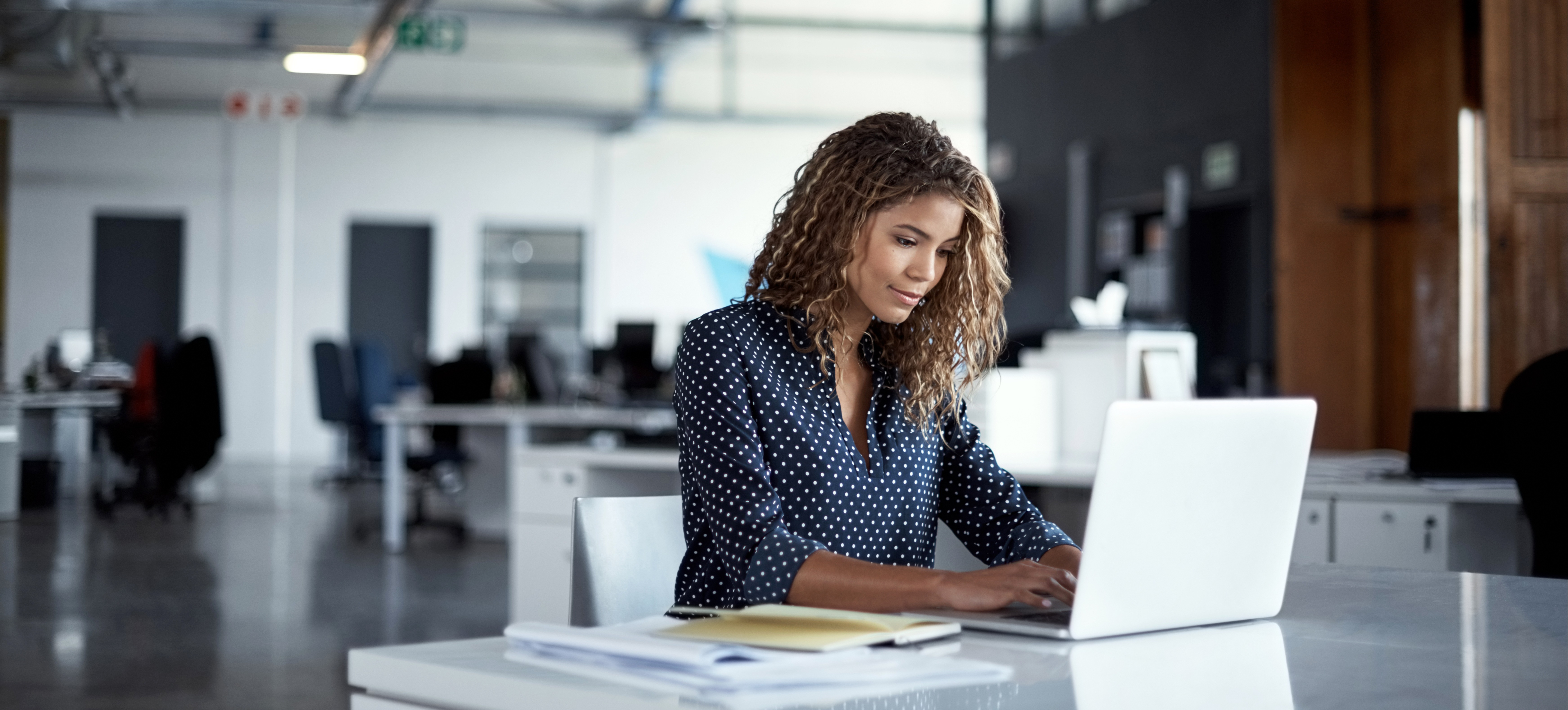 [Featured Image] A software developer works on building the application layer and relevant protocols for a new program.
