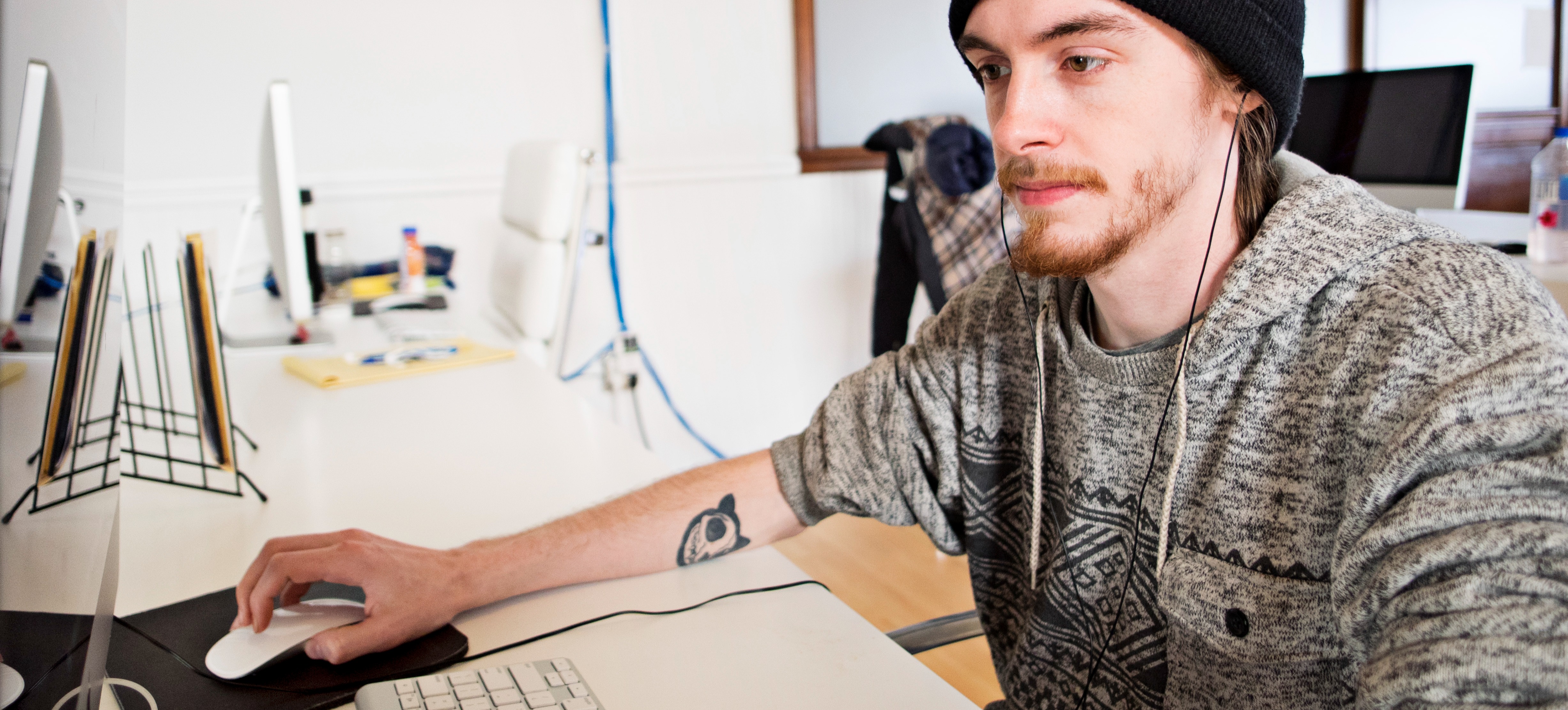 [Featured Image] A data scientist sits at a desk working on their computer.
