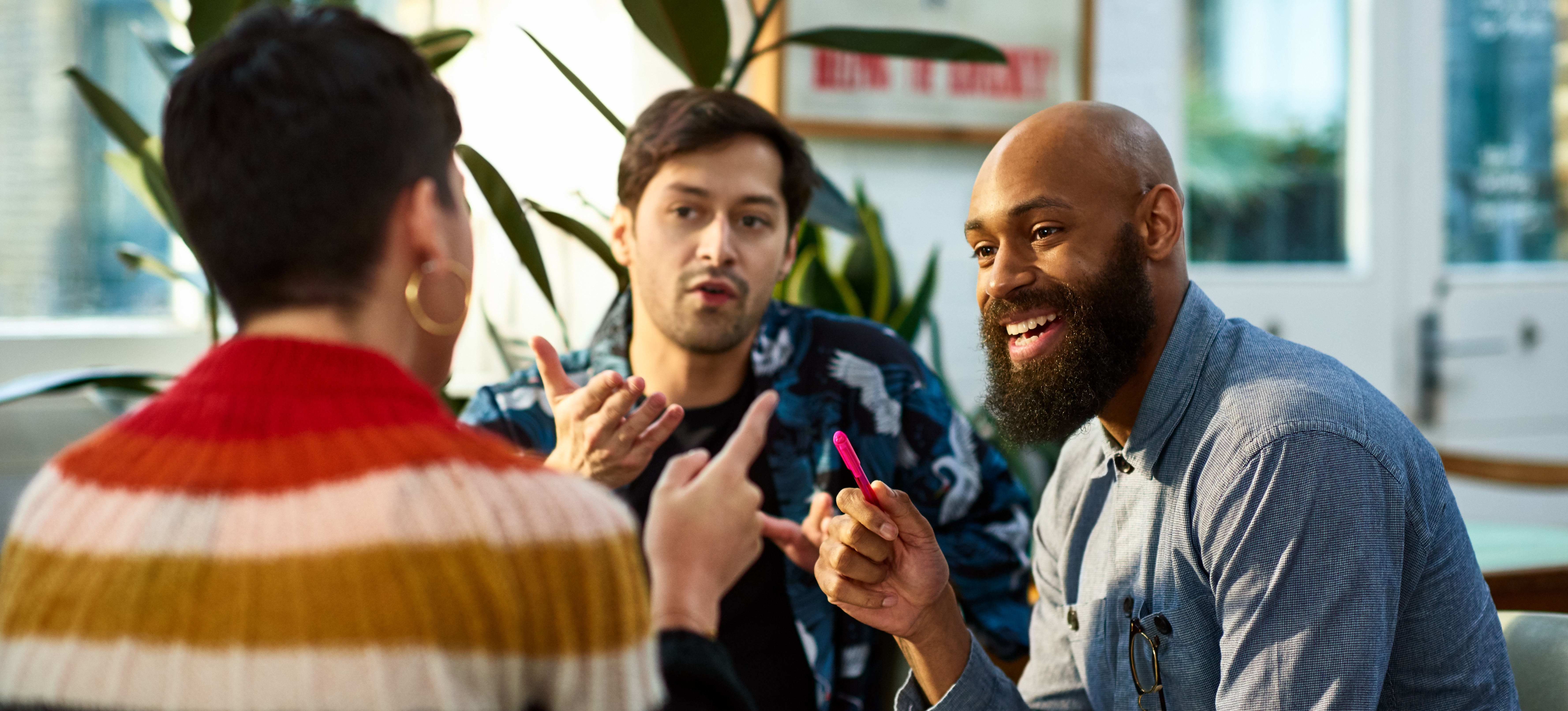 [Featured image] Diverse colleagues discussing what is the best AI image generator in a team meeting.