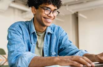 [Featured Image] An office employee learns how to password protect Google Sheets on his laptop. 