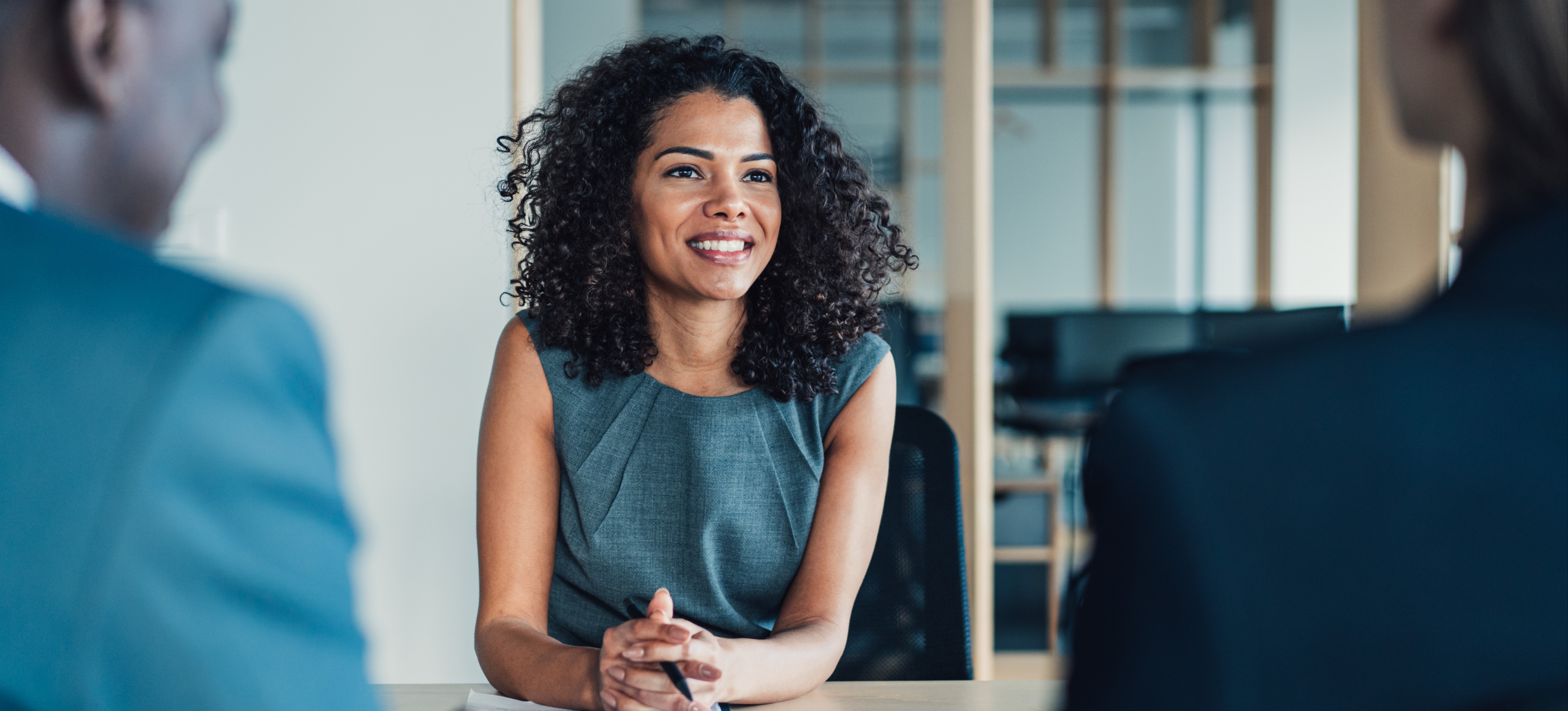 [Featured image: A sales manager in an office, explaining their sales pipeline management strategy to two other people.]
