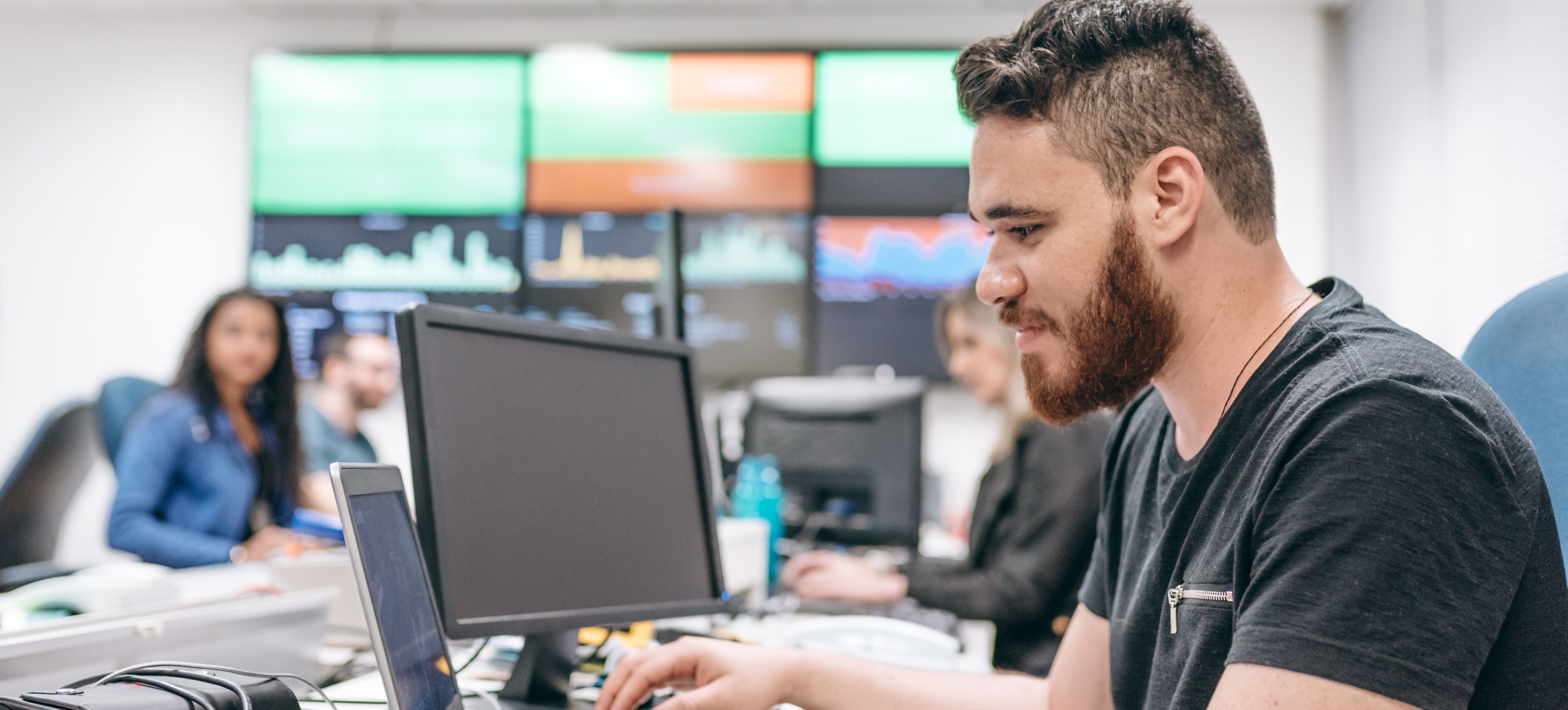 [Featured Image] A person working in a finance office is tracking data using machine learning programs.
