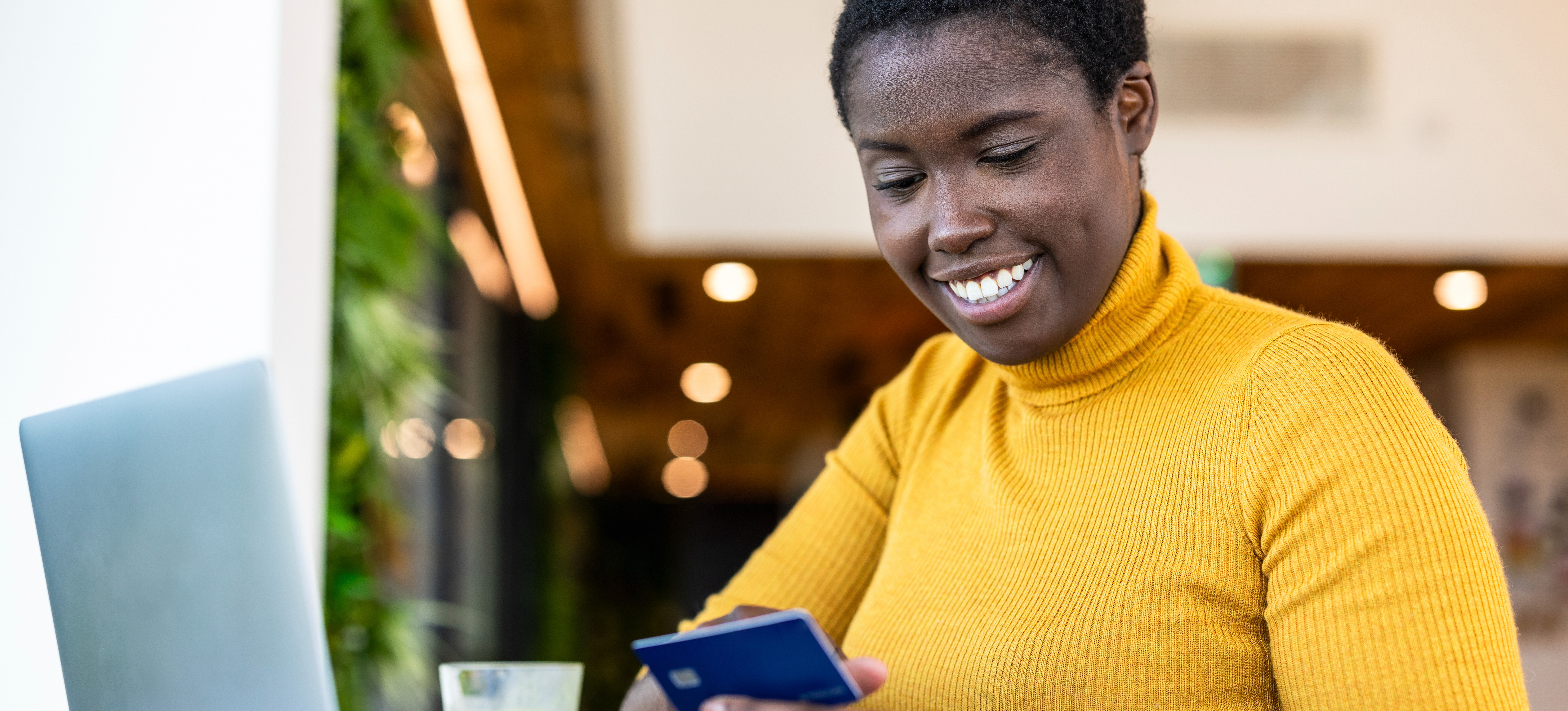 [Featured Image] An email marketing professional works at a desk, using various tools to boost their email marketing campaign.
