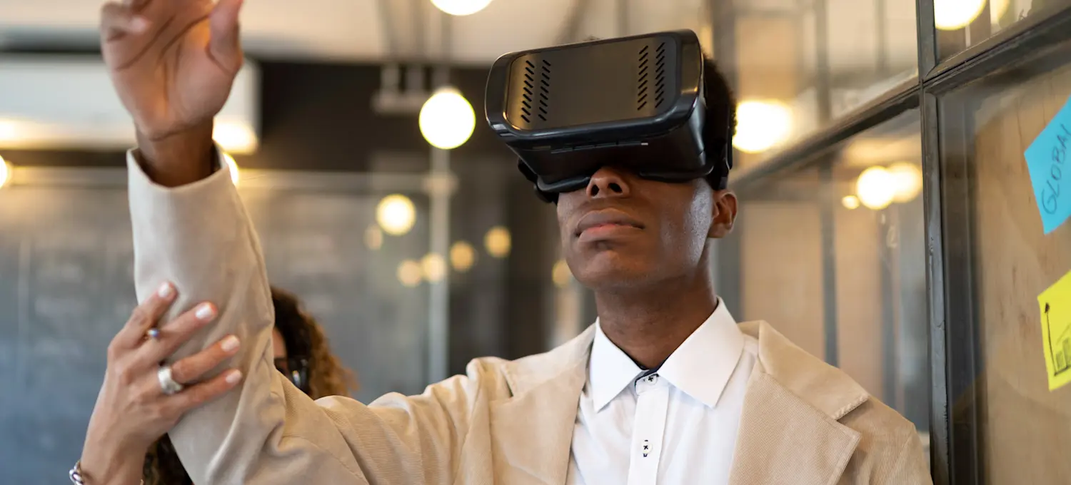 [Feature Image] A member of the VR game development team tests the latest iteration of a game they have been working on.
