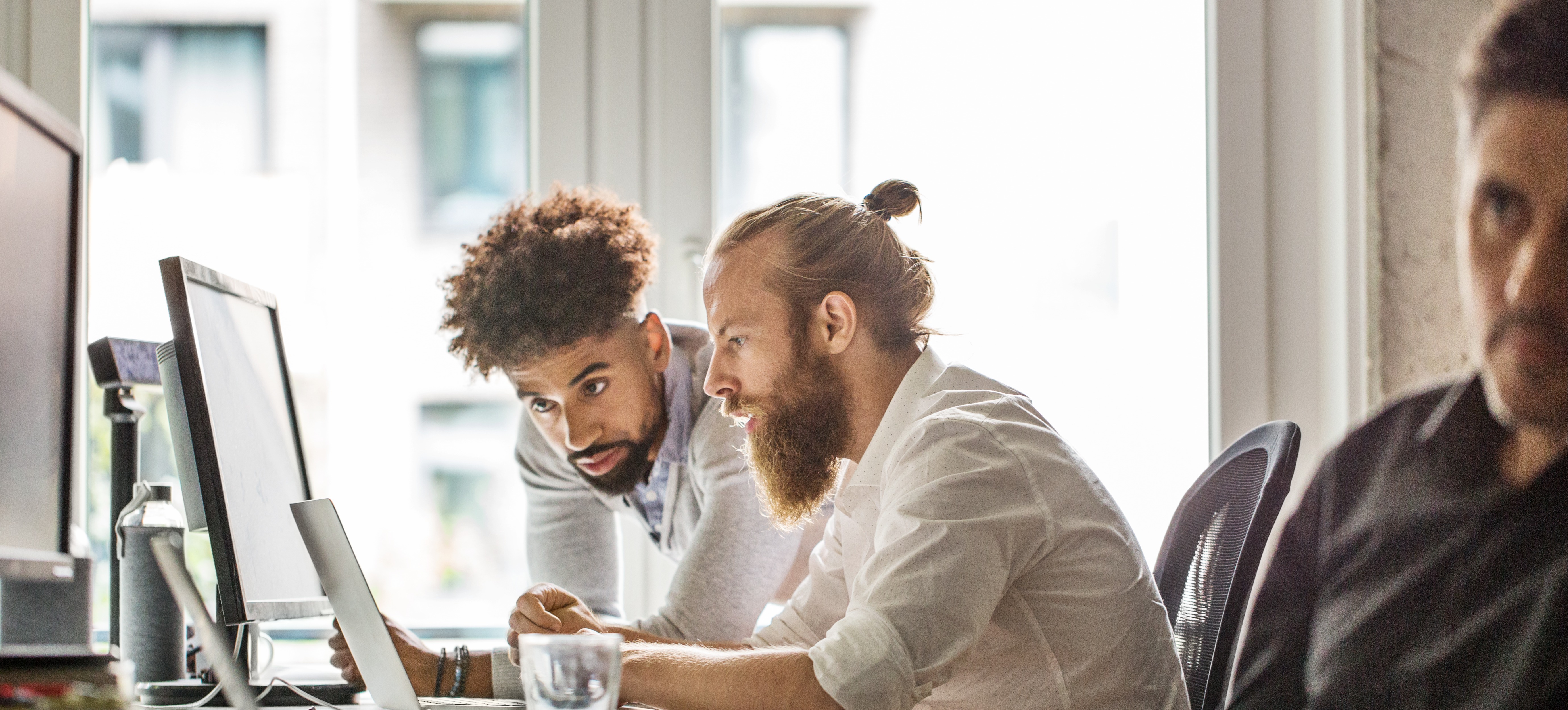 [Feature Image] An aspiring Python developer works on Python application development with another learner. 
