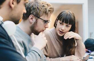 [Featured image] A team of three UX researchers analyzes the results of a between subjects study.