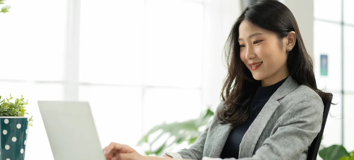 [Featured Image] A digital marketer sits at a laptop and uses data mining to analyze customer behavior. 