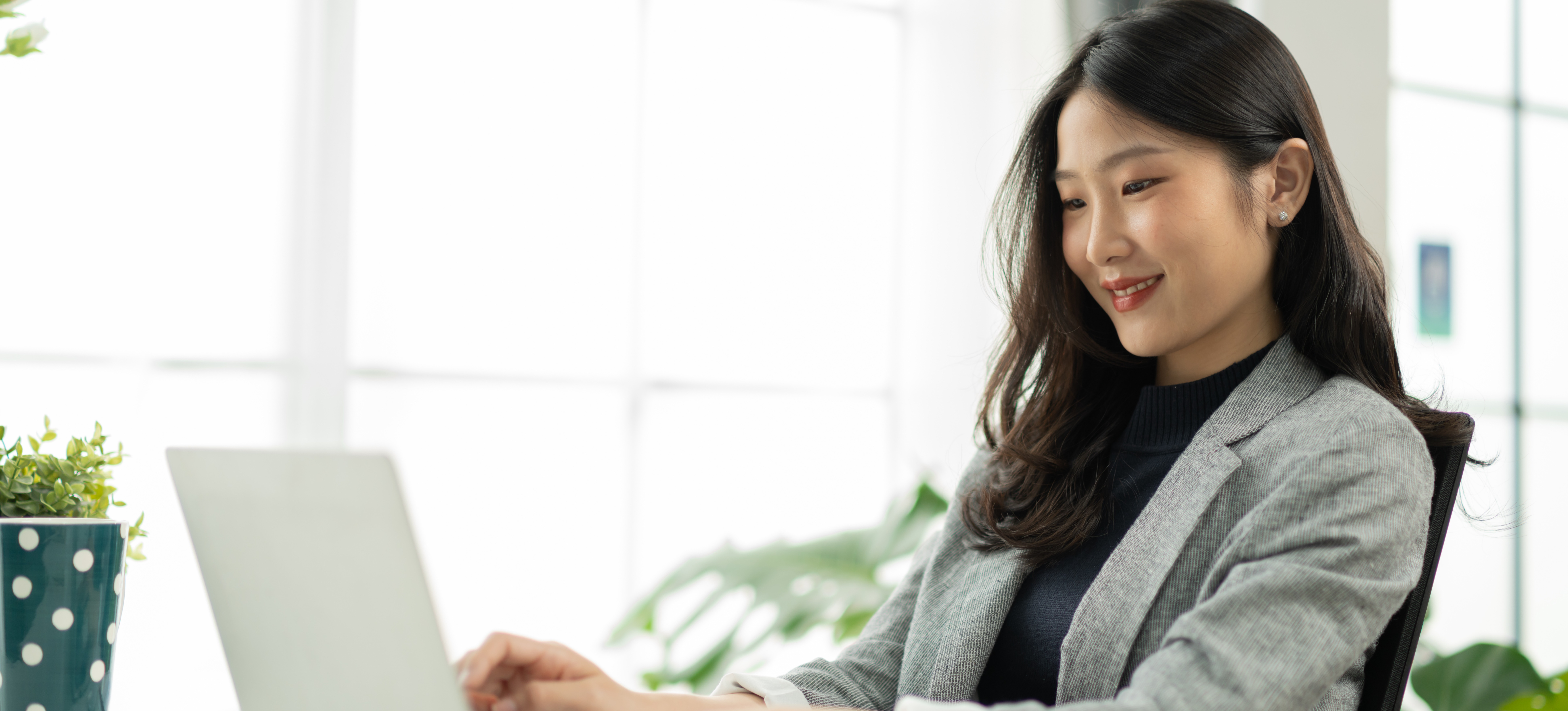 [Featured Image] A digital marketer sits at a laptop and uses data mining to analyze customer behavior. 