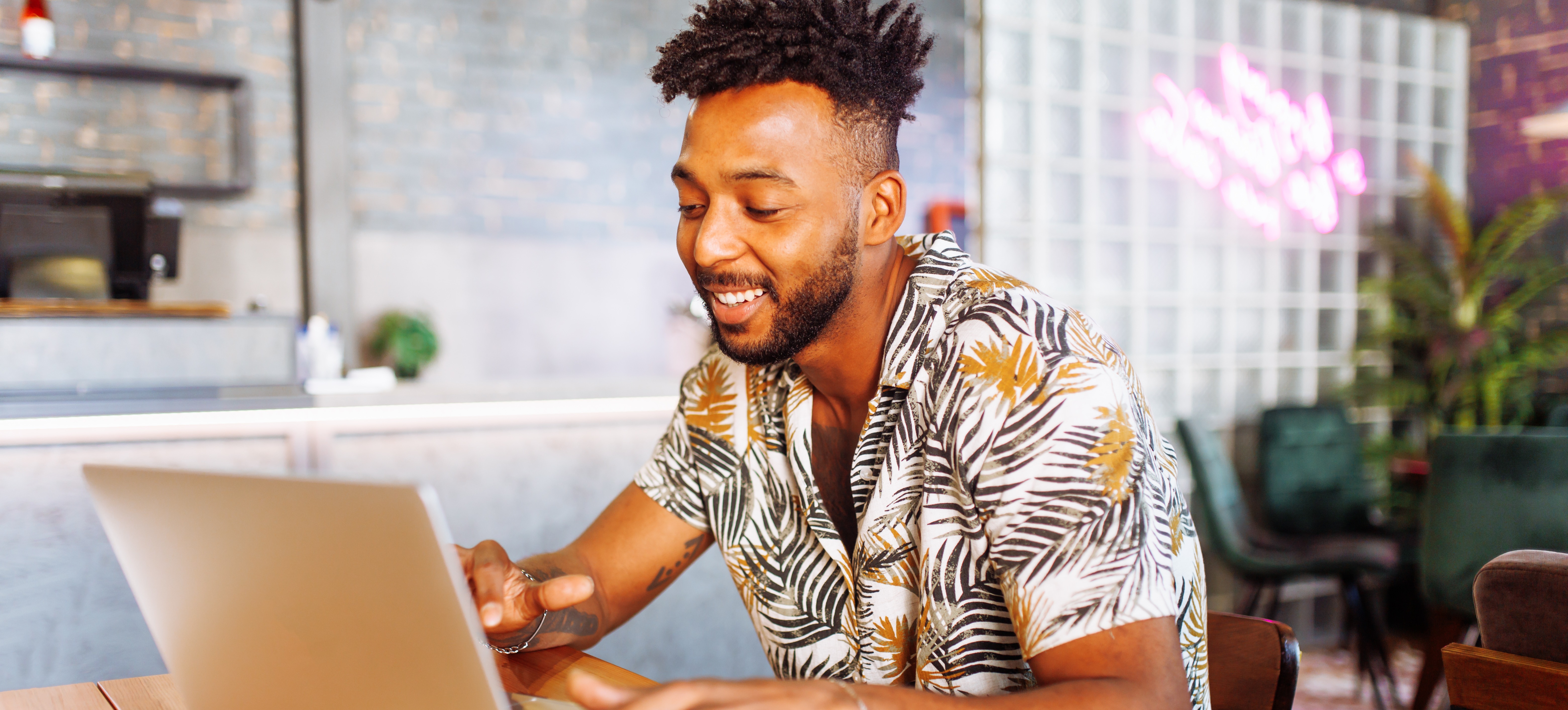 [Featured Image] A marketing professional works on a laptop, applying strategies learned from their master’s in marketing.
