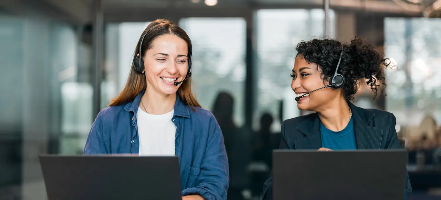 [Featured Image] Two product support engineers are answering calls from clients with software and hardware issues.