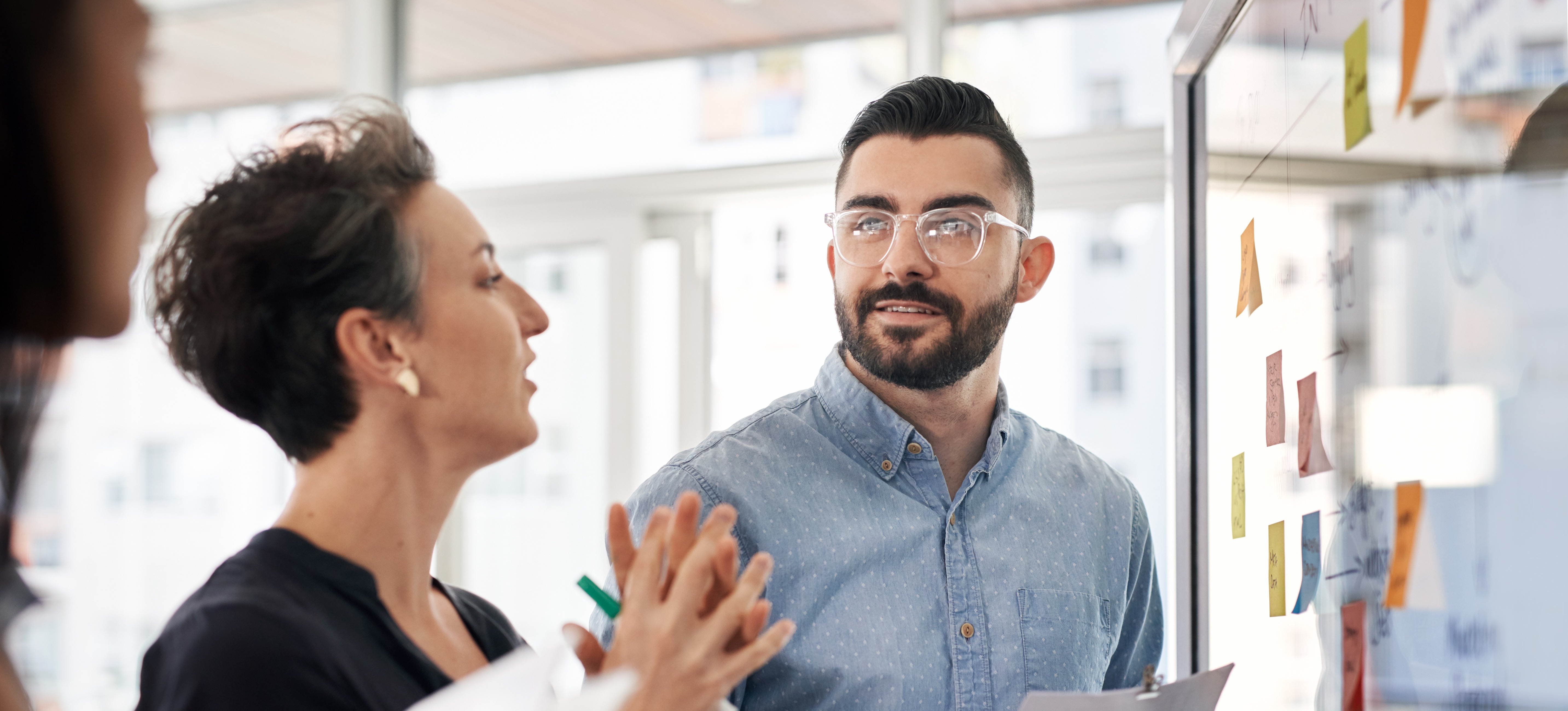[Featured Image]: Supply chain manager discussing strategies with a team member.