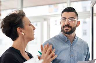 [Featured Image]: Supply chain manager discussing strategies with a team member.