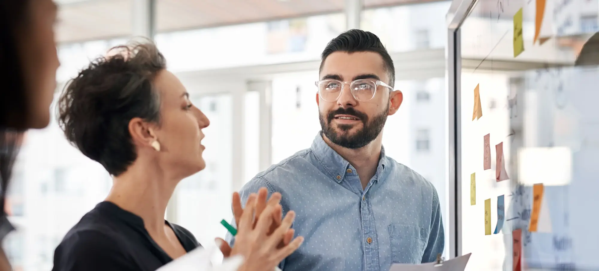 [Featured Image]: Supply chain manager discussing strategies with a team member.