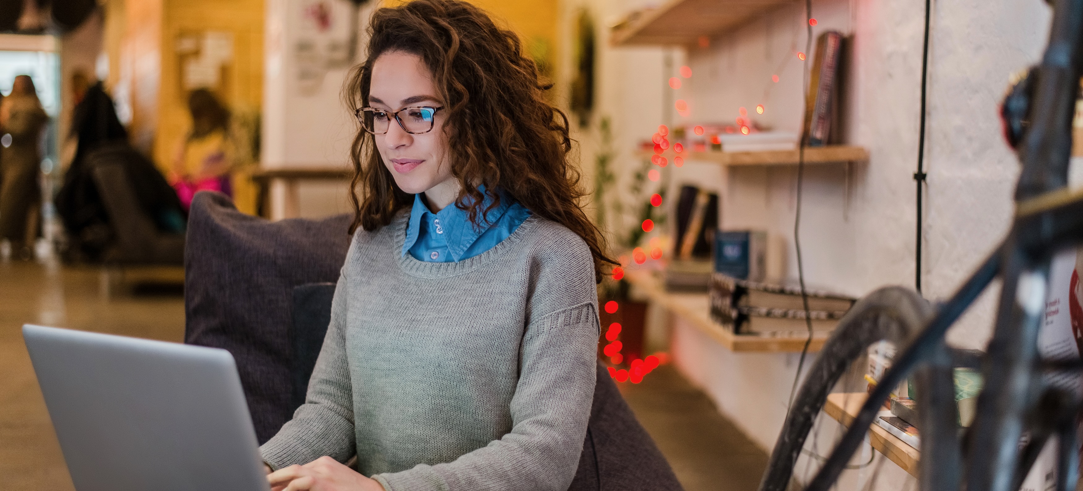 [Featured Image] A DevOps engineer works on their resume in a coffee shop while looking at their laptop.