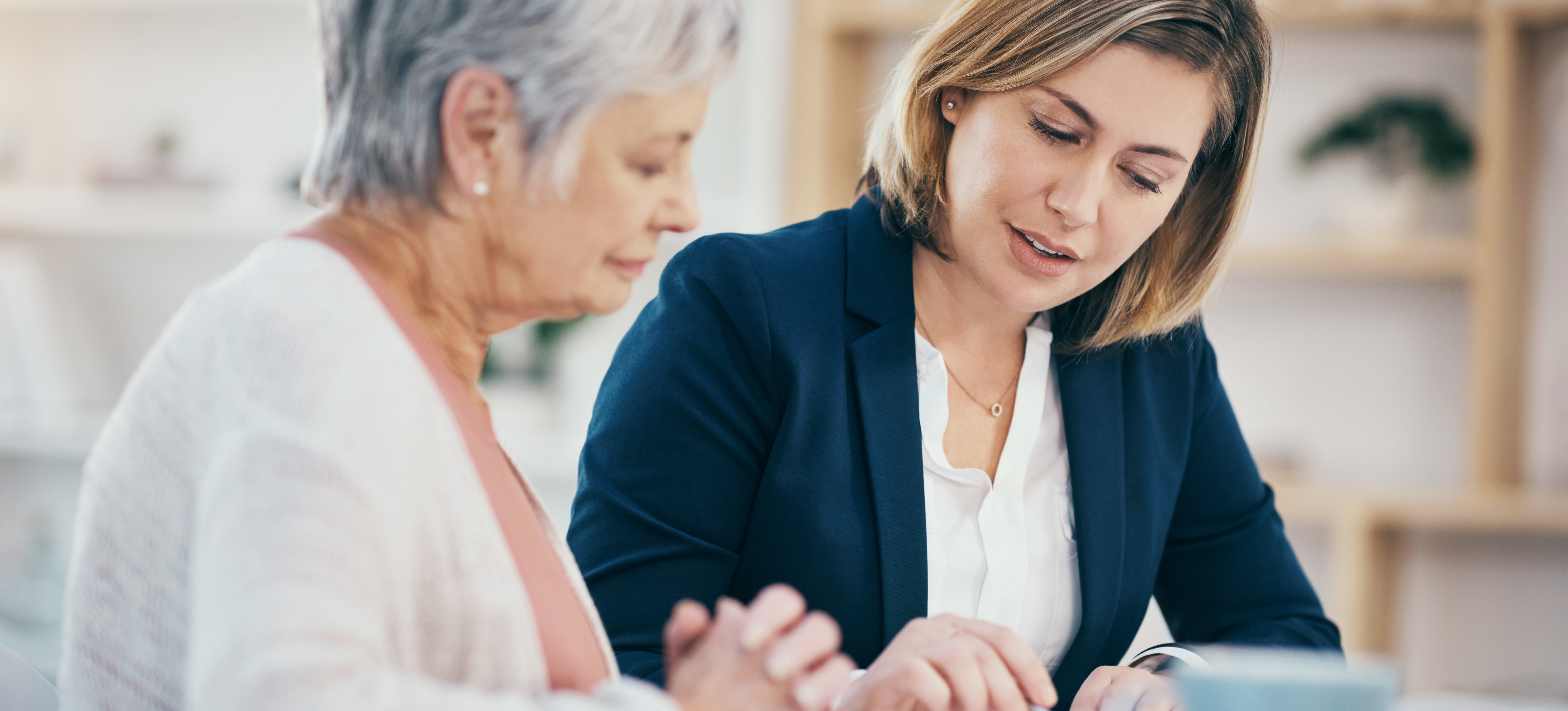 [Featured Image] A financial advisor meets with a client to discuss financial strategy, as the financial advisor points to the papers on the table in front of them.
