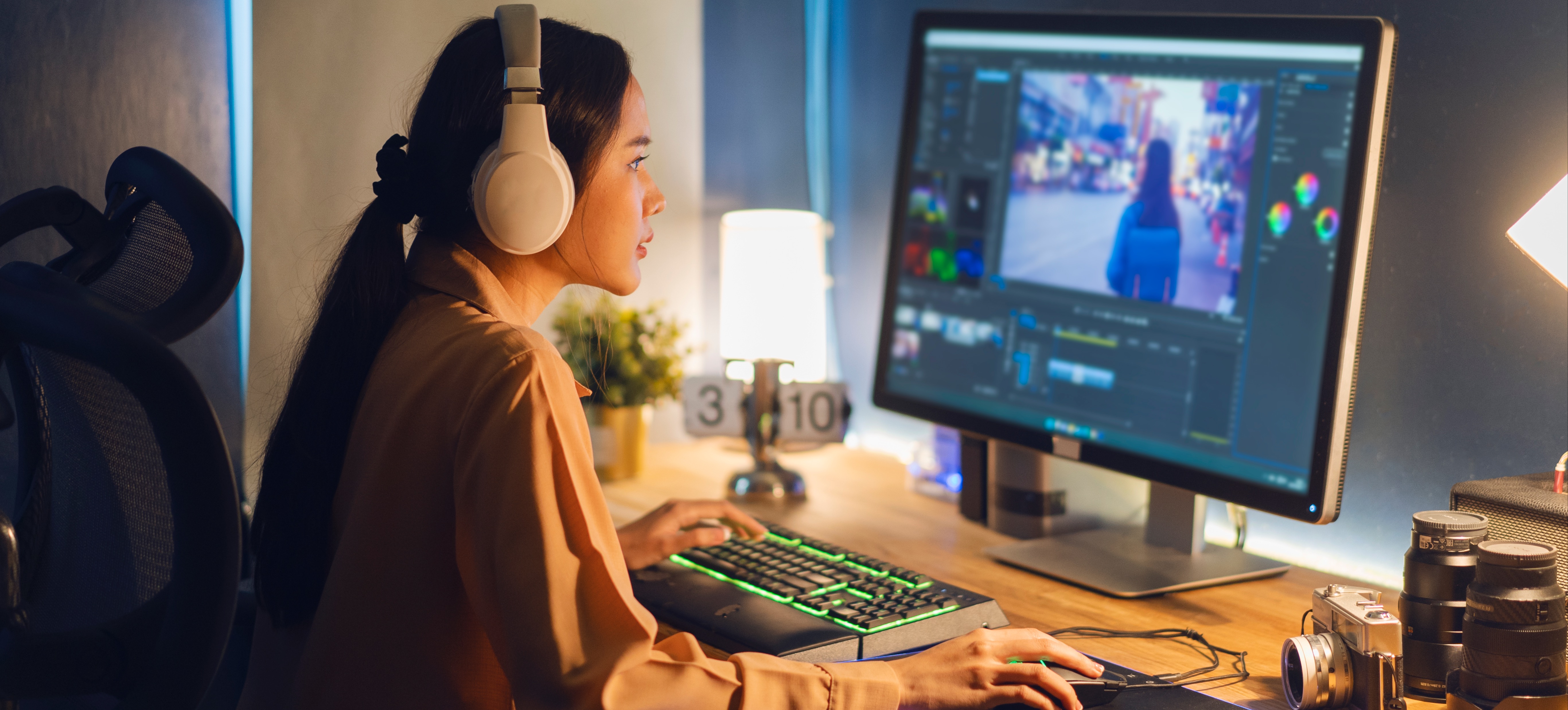 [Featured Image] A graphic designer working on a project in a home office focuses on their design work.