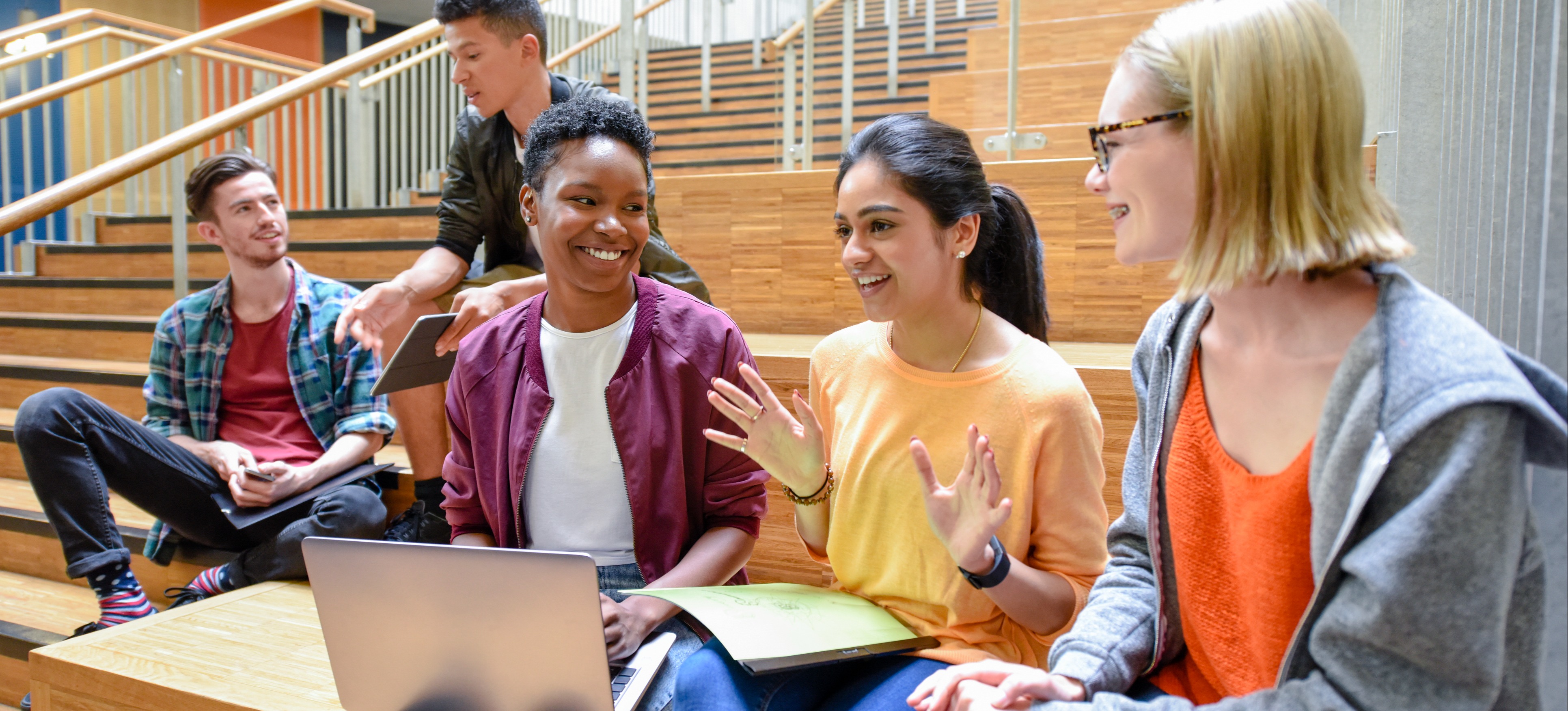 [Featured image]: A group of STEM degree students study together inside near a staircase.
